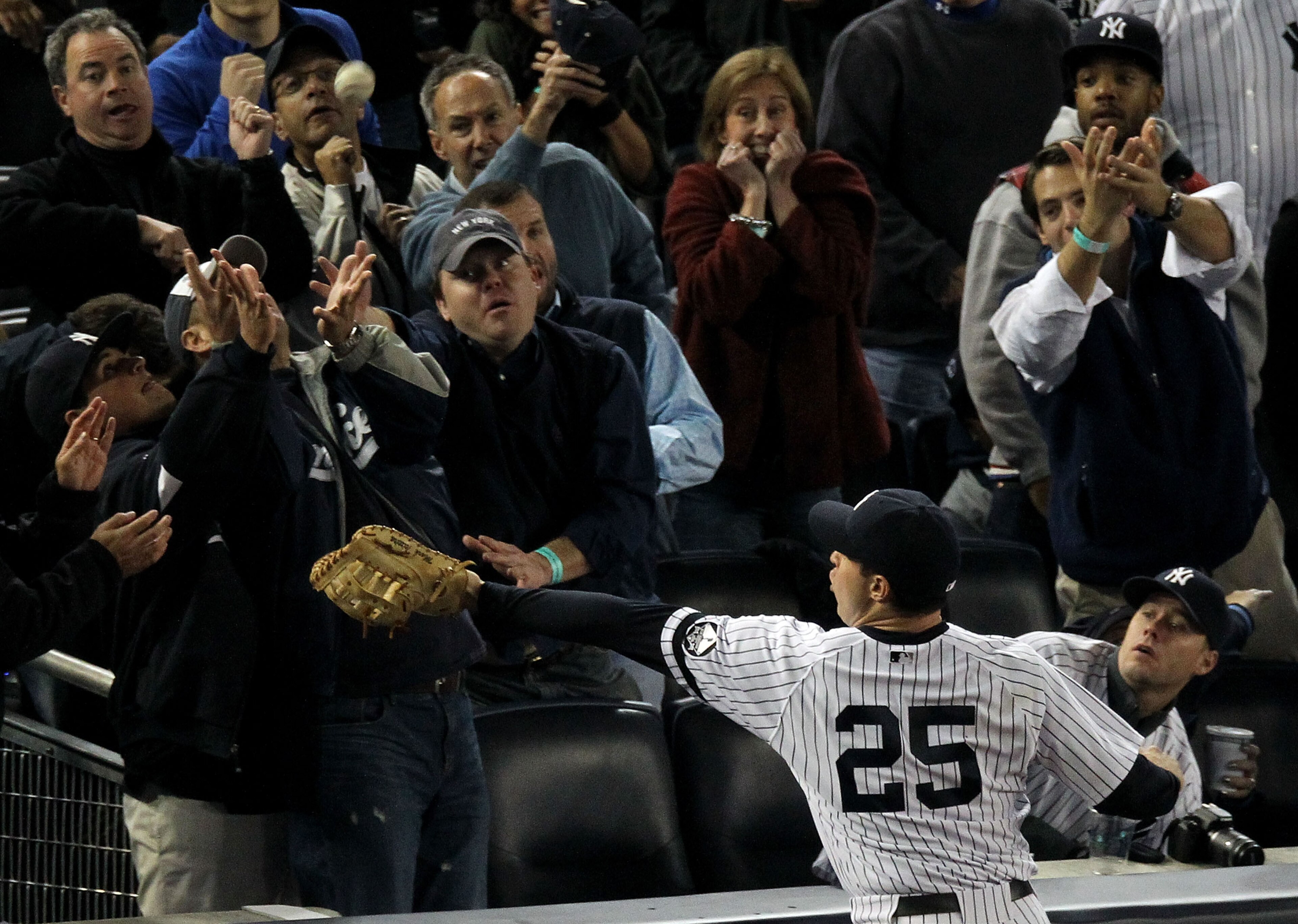 NEW YORK - OCTOBER 19: Mark Teixeira #25 of the New York Yankees fails to make a play on a foul ball hit into the stands in the top of the fourth inning against the Texas Rangers in Game Four of the ALCS during the 2010 MLB Playoffs at Yankee Stadium on NEW YORK - OCTOBER 19: Mark Teixeira #25 of the New York Yankees fails to make a play on a foul ball hit into the stands in the top of the fourth inning against the Texas Rangers in Game Four of the ALCS during the 2010 MLB Playoffs at Yankee Stadium on
