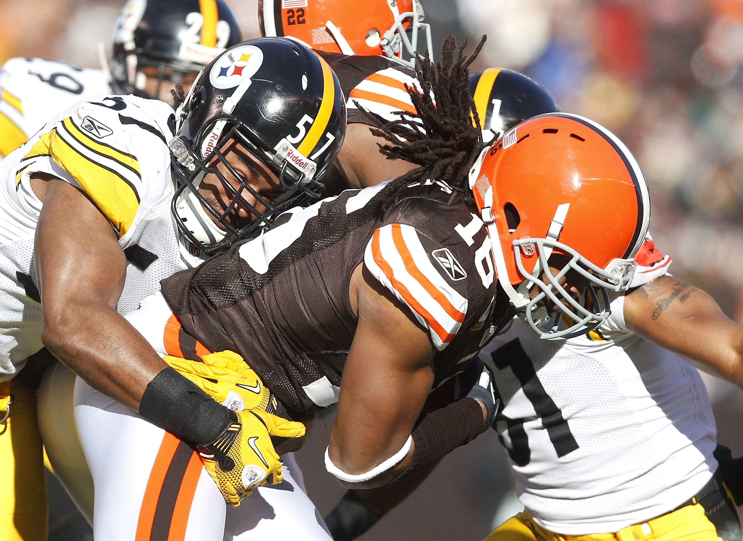 CLEVELAND, OH - JANUARY 02:  Linebacker Keyaron Fox #57 of the Pittsburgh Steelers tackles wide receiver Joshua Cribbs #16 of the Cleveland Browns at Cleveland Browns Stadium on January 2, 2011 in Cleveland, Ohio.  (Photo by Matt Sullivan/Getty Images)