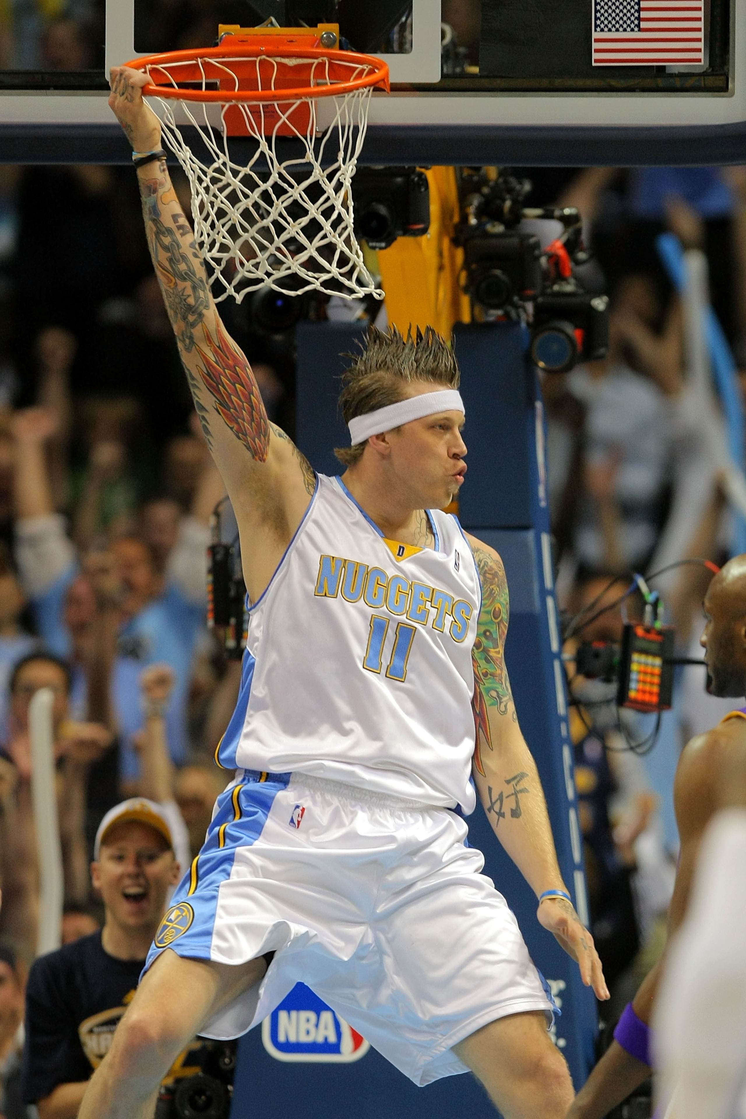 DENVER - MAY 23:  Chris Andersen #11 of the Denver Nuggets hangs on the rim after he dunks the ball in the first quarter against the Los Angeles Lakers in Game Three of the Western Conference Finals during the 2009 NBA Playoffs at Staples Center on May 23