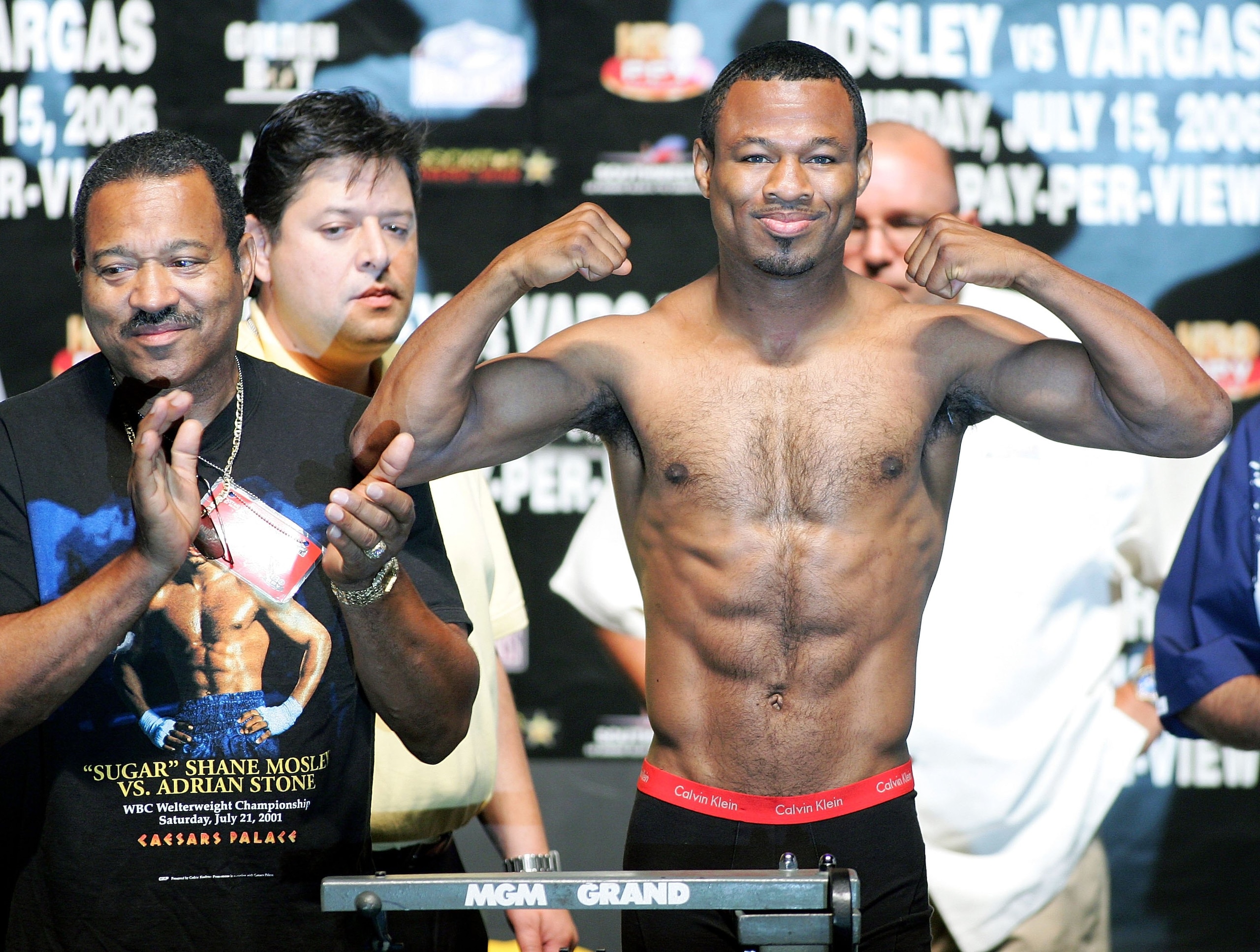 LAS VEGAS - JULY 14:  Junior middleweight boxer Shane Mosley of California poses, weighing in at 153 pounds, as his father, trainer and manager Jack Mosley (L) applauds at the MGM Grand Garden Arena July 14, 2006 in Las Vegas, Nevada. Mosley will take on 