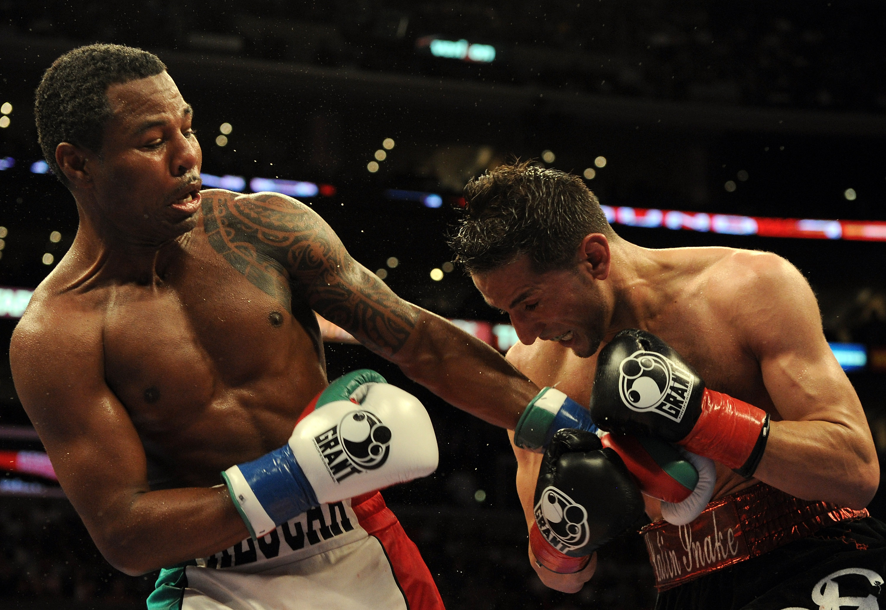 LOS ANGELES, CA - SEPTEMBER 18:  (Left) Shane Mosley and Sergio Mora fight to a draw during the eighth round in a Middleweight bout at Staples Center on September 18, 2010 in Los Angeles, California.  (Photo by Harry How/Getty Images)
