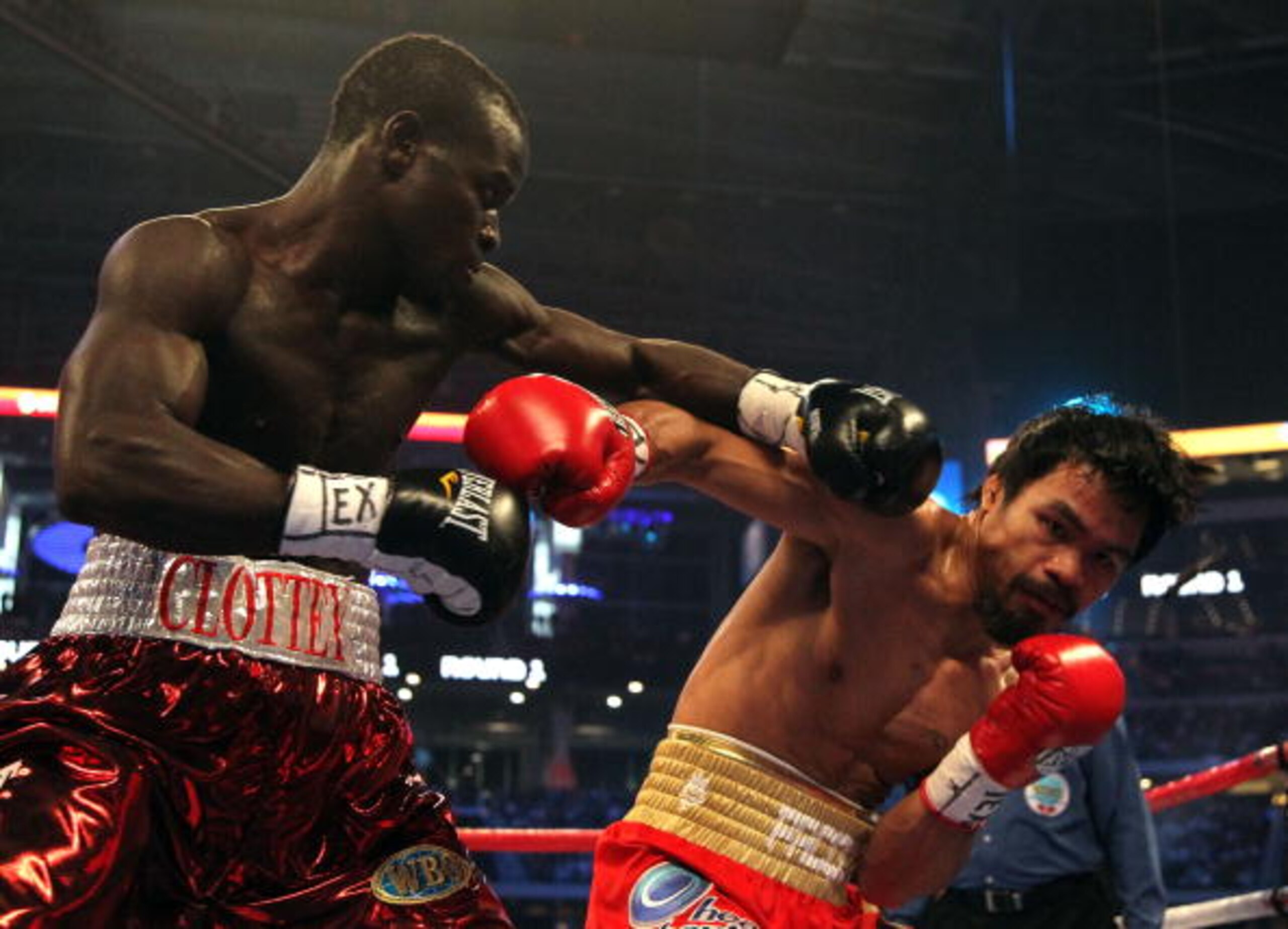 ARLINGTON, TX - MARCH 13:  (L-R) Joshua Clottey of Ghana and Manny Pacquiao of the Philippines exchange blows in the first round during the WBO welterweight title fight at Cowboys Stadium on March 13, 2010 in Arlington, Texas.  (Photo by Jed Jacobsohn/Get