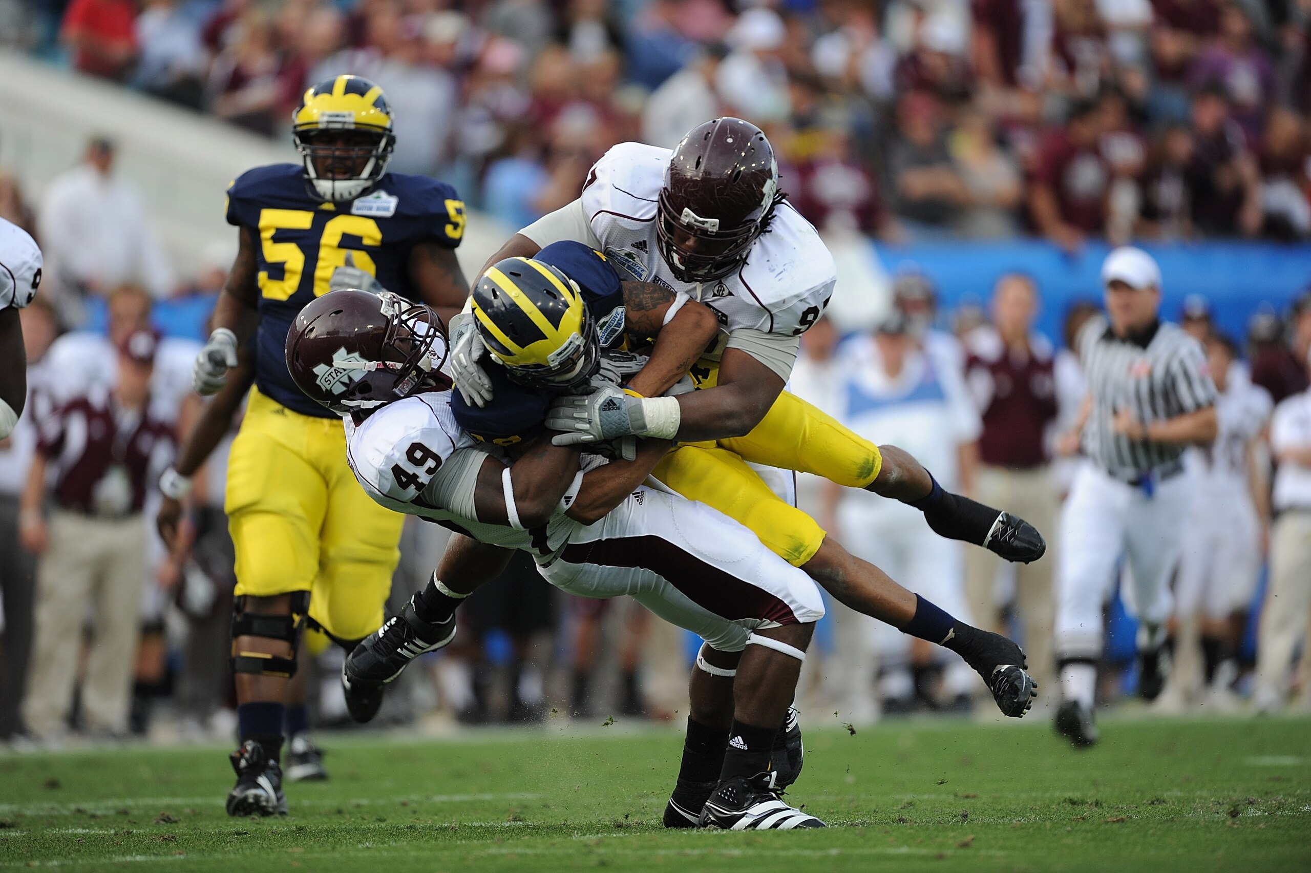 JACKSONVILLE, FL - JANUARY 01:  Roy Roundree #12 of the Michigan Wolverines is tackled by the Mississippi State Bulldogs during the Gator Bowl at EverBank Field on January 1, 2011 in Jacksonville, Florida  (Photo by Rick Dole/Getty Images)