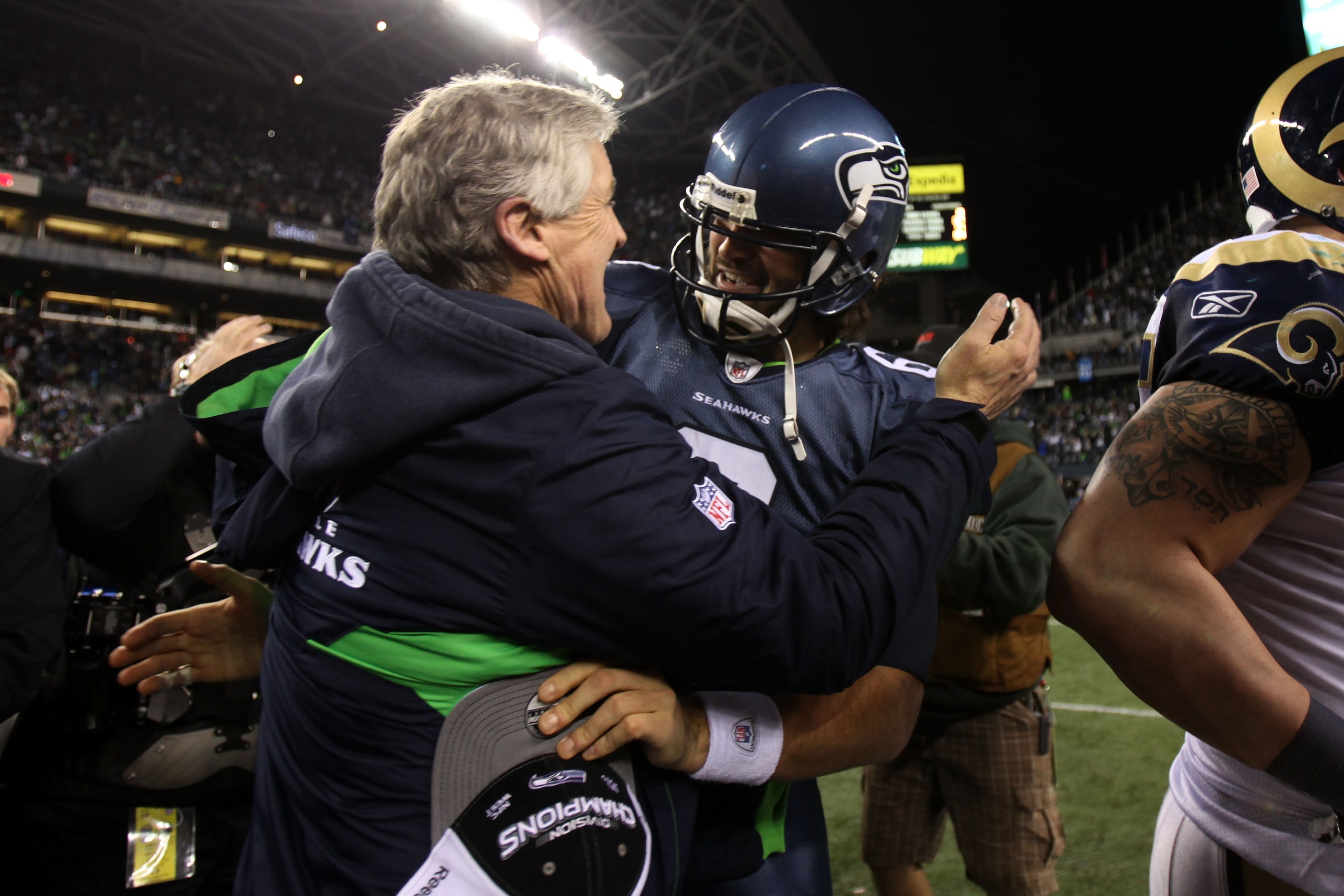 SEATTLE, WA - JANUARY 02:  Head coach Pete Carroll of the Seattle Seahawks hugs quarterback Charlie Whitehurst #6 after defeating the St. Louis Rams 16-6 at Qwest Field on January 2, 2011 in Seattle, Washington. The Seahawks became the first team to advan