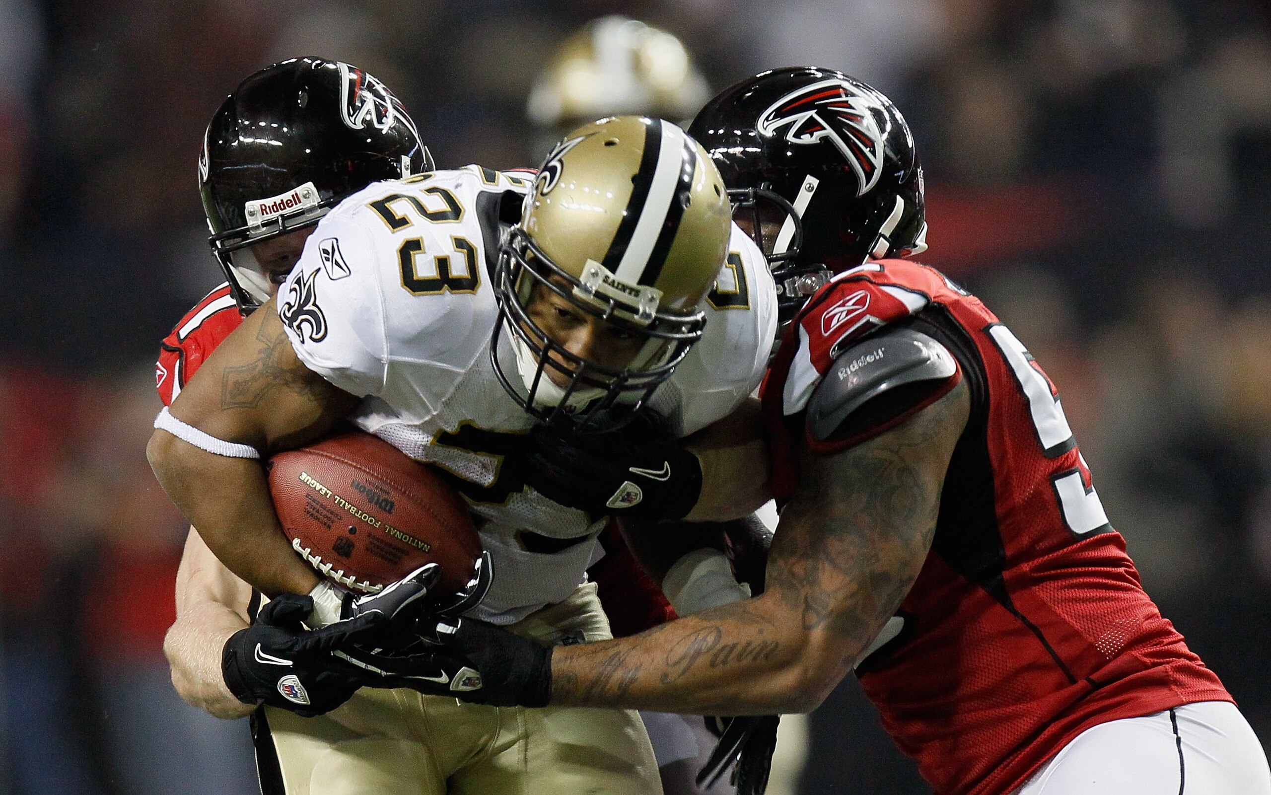 ATLANTA, GA - DECEMBER 27:  Pierre Thomas #23 of the New Orleans Saints fights off two defenders in the first half during the game against the Atlanta Falcons at the Georgia Dome on December 27, 2010 in Atlanta, Georgia.  (Photo by Kevin C. Cox/Getty Imag