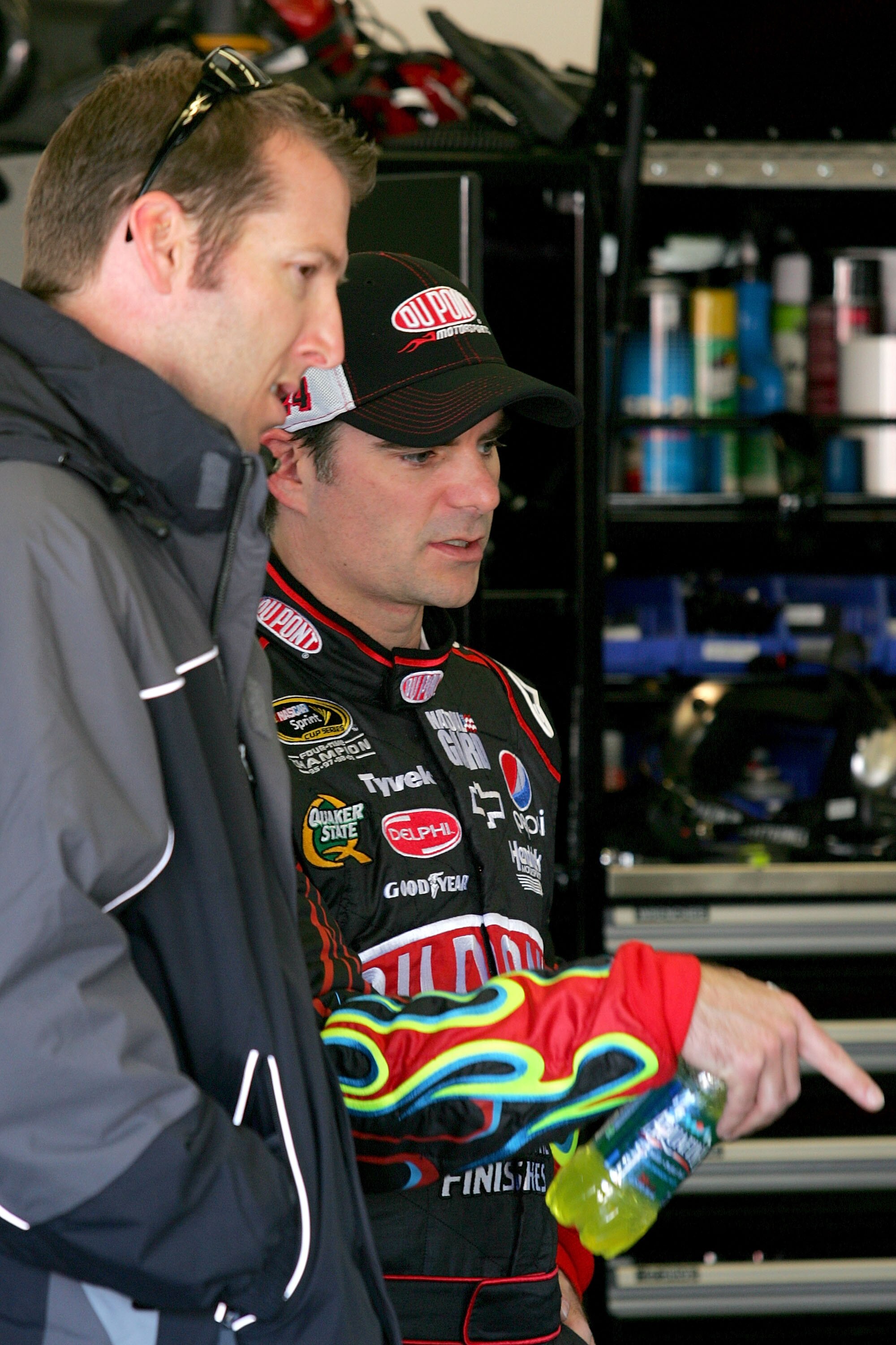 DAYTONA BEACH, FL - FEBRUARY 10:  Alan Gustafson (L), crew chief for Mark Martin (not pictured), driver of the #5 GoDaddy.com Chevrolet, and Jeff Gordon, driver of the #24 DuPont Chevrolet, talk in the garage during practice for the NASCAR Sprint Cup Seri
