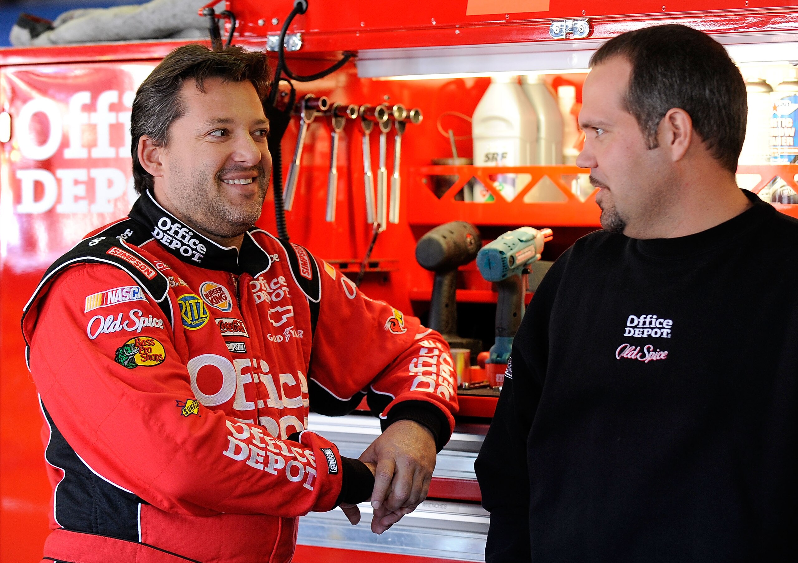 TALLADEGA, AL - OCTOBER 29: Tony Stewart (L), driver of the #14 Old Spice/Office Depot Chevrolet, talks with crew chief Darian Grubb in the garage during practice for the NASCAR Sprint Cup Series AMP Energy Juice 500 at Talladega Superspeedway on October TALLADEGA, AL - OCTOBER 29: Tony Stewart (L), driver of the #14 Old Spice/Office Depot Chevrolet, talks with crew chief Darian Grubb in the garage during practice for the NASCAR Sprint Cup Series AMP Energy Juice 500 at Talladega Superspeedway on October