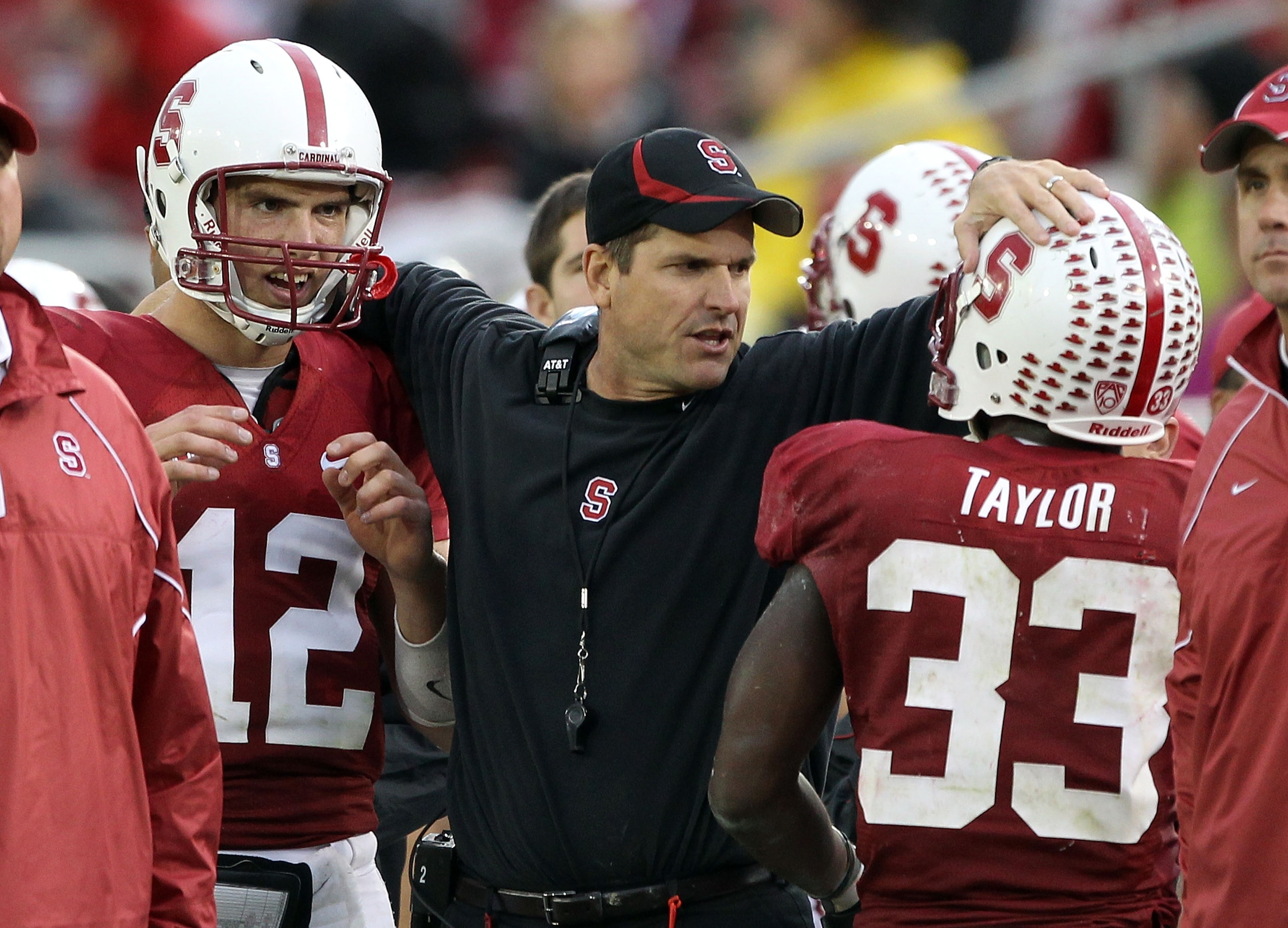 PALO ALTO, CA - OCTOBER 23:  Head coach Jim Harbaugh congratulates Andrew Luck #12 and Stepfan Taylor #33 of the Stanford Cardinal after the Cardinal scored a touchdown against the Washington State Cougars at Stanford Stadium on October 23, 2010 in Palo A