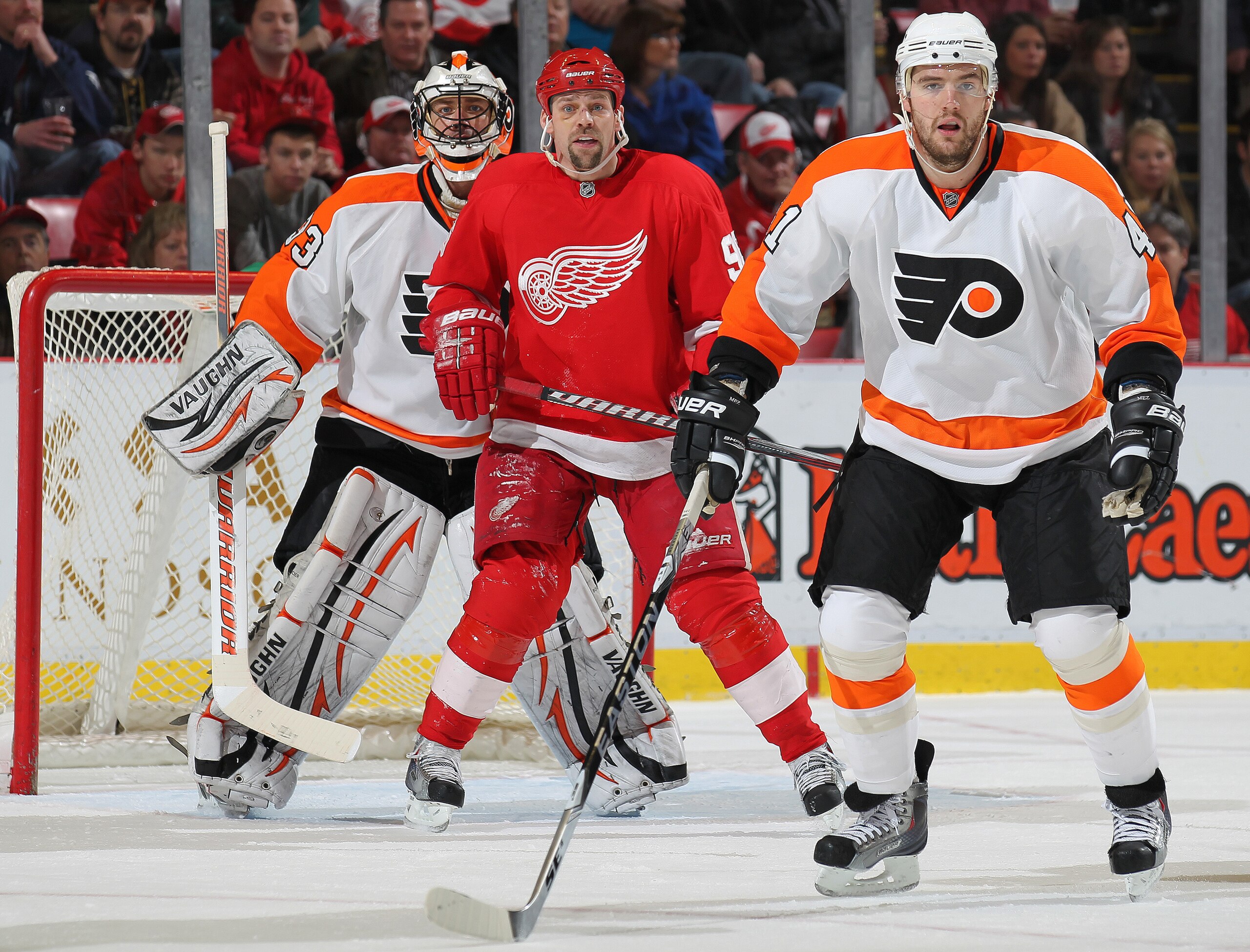 DETROIT, MI - JANUARY 2:  Tomas Holmstrom #96 of the Detroit Red Wings waits to deflect an incoming shot between Brian Boucher #33 and Andrej Meszaros #41 of the Philadelphia Flyers in a game on January 2, 2011 at the Joe Louis Arena in Detroit, Michigan.