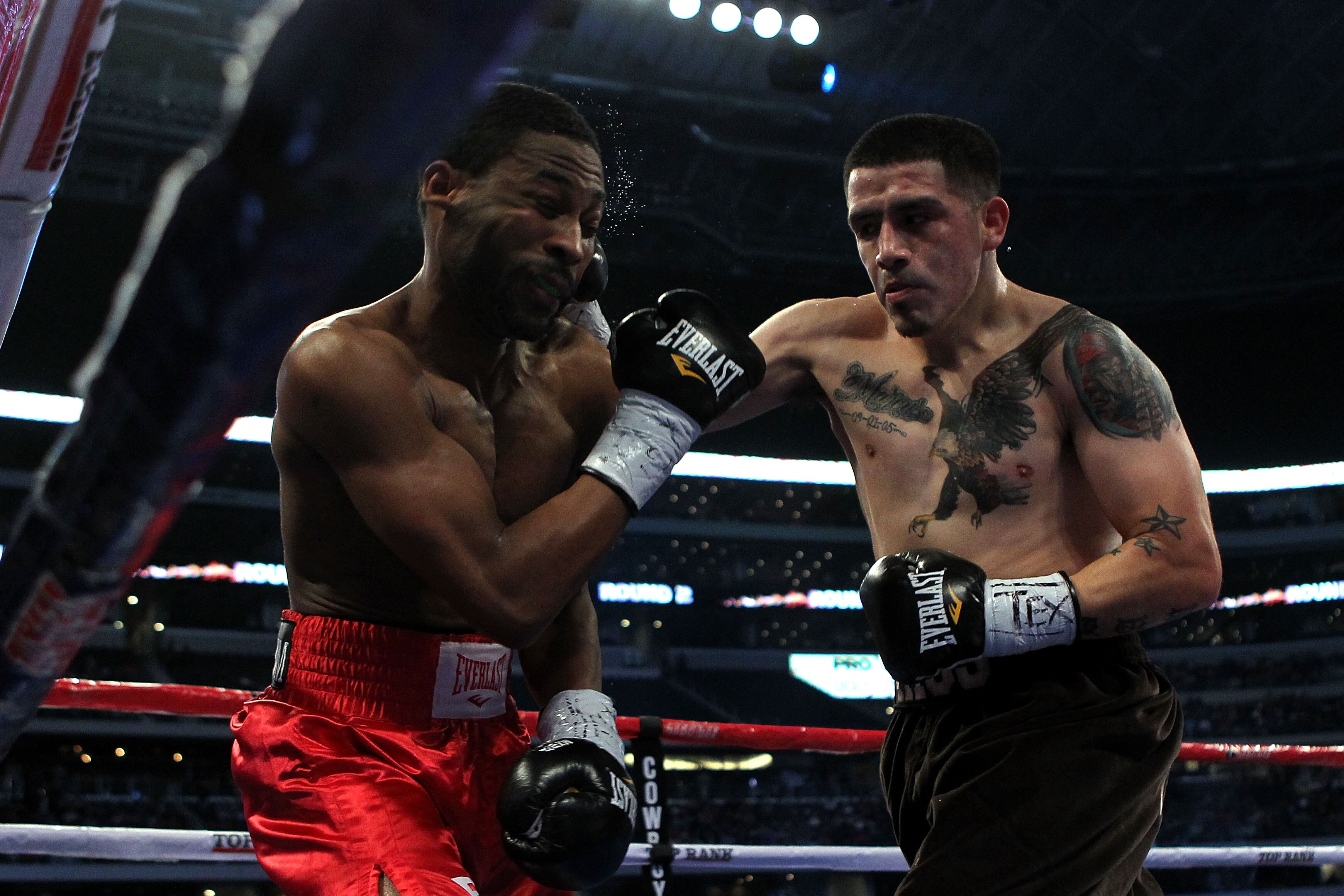 ARLINGTON, TX - NOVEMBER 13:  Brandon Rios (R in brown trunks) lands a punch against Omri Lowther (red trunks) during their Super Lightweight bout at Cowboys Stadium on November 13, 2010 in Arlington, Texas.  (Photo by Nick Laham/Getty Images)
