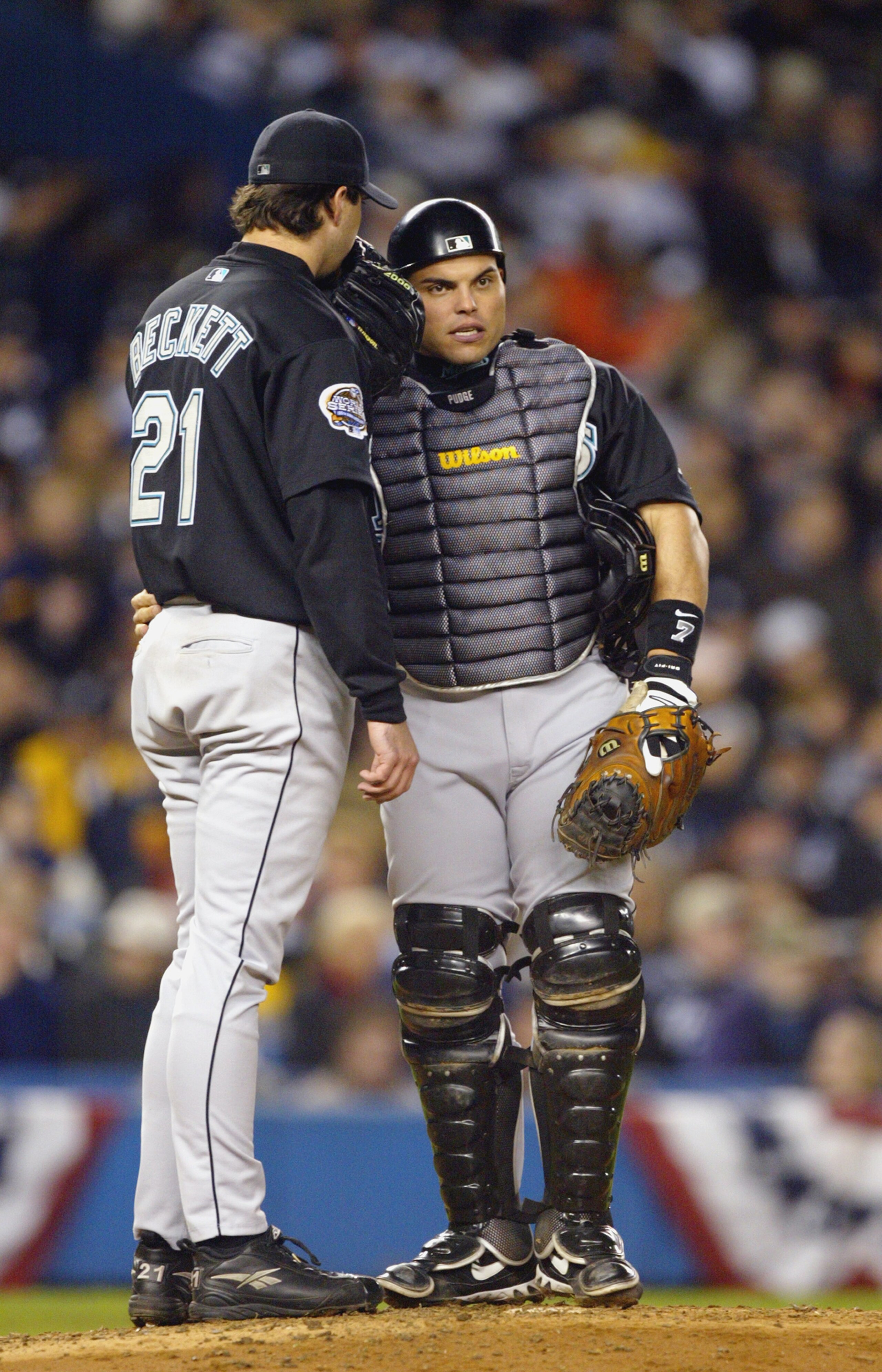 BRONX, NY - OCTOBER 25:  Starting pitcher Josh Beckett #21 and catcher Ivan Rodriguez #7 of the Florida Marlins talk on the mound during game six of the Major League Baseball World Series against the New York Yankees on October 25, 2003 at Yankee Stadium 