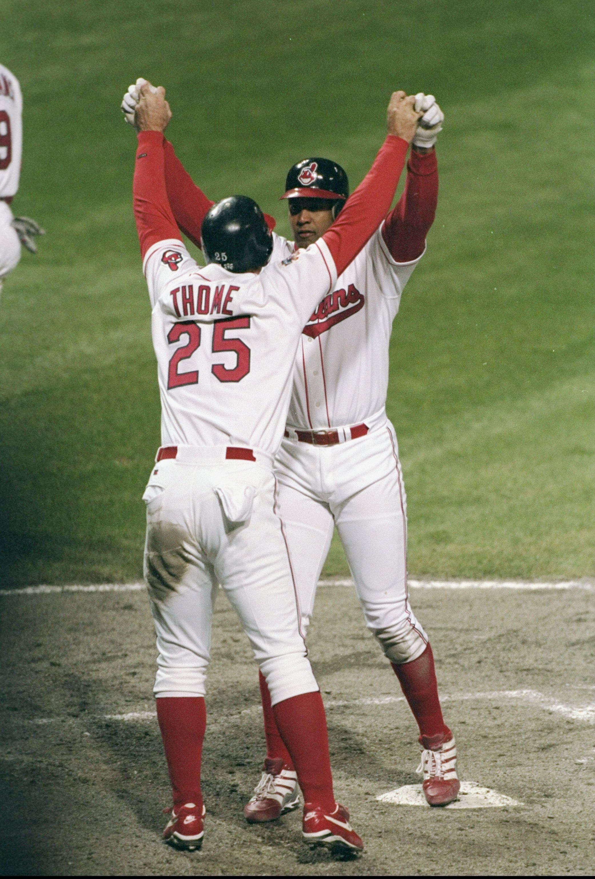 23 Oct 1997:  Catcher Sandy Alomar of the Cleveland Indians clasps hands with teammate first baseman Jim Thome during the fifth game of the World Series against the Florida Marlins at Jacobs Field in Cleveland, Ohio.  The Marlins won the game 8-7. Mandato