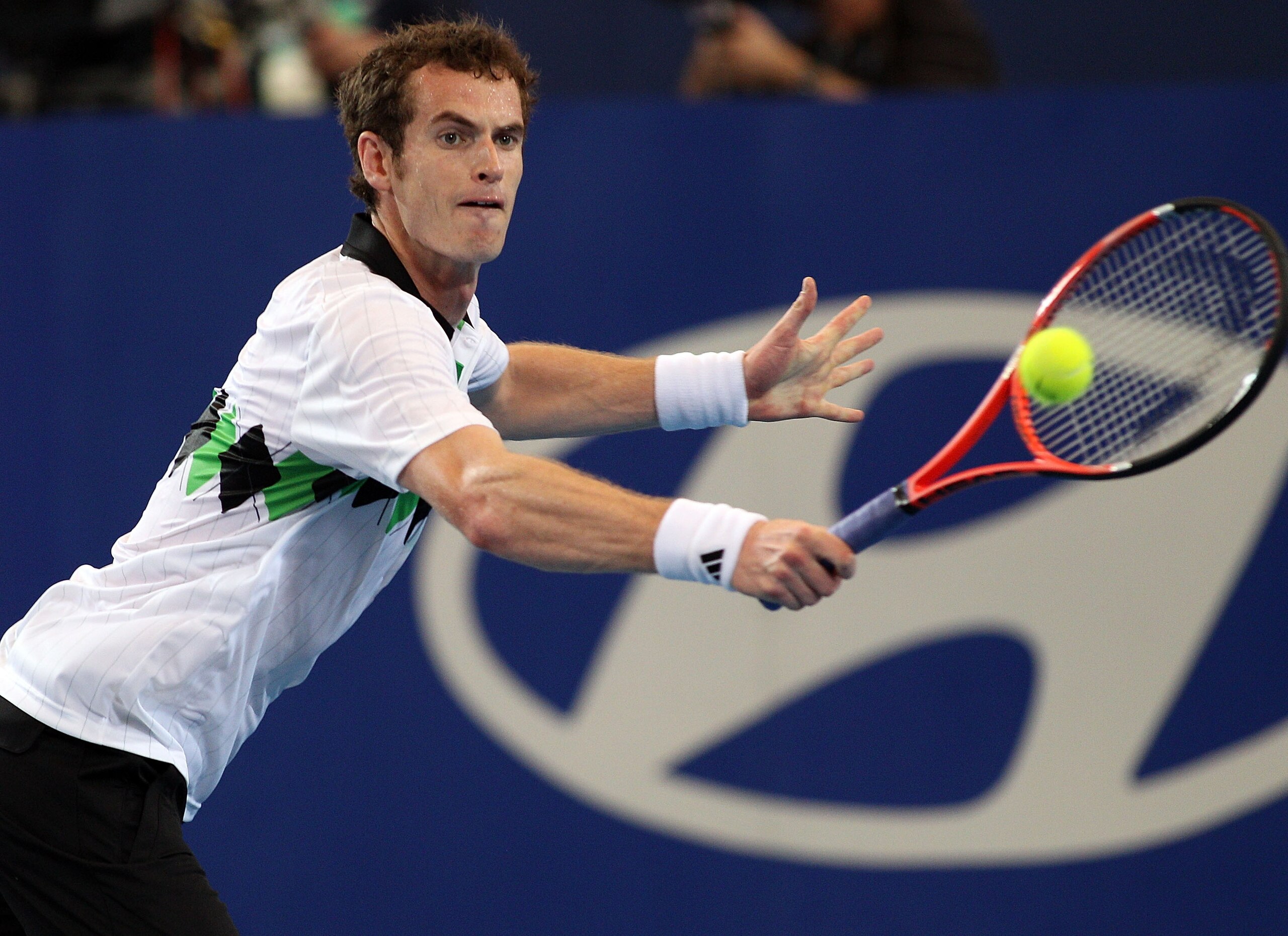 PERTH, AUSTRALIA - JANUARY 03:  Andy Murray of Great Britain plays a return shot during his mixed doubles match against Francesca Schiavone and Potito Starace of Italy on day three of the Hopman Cup on January 3, 2011 in Perth, Australia.  (Photo by Paul