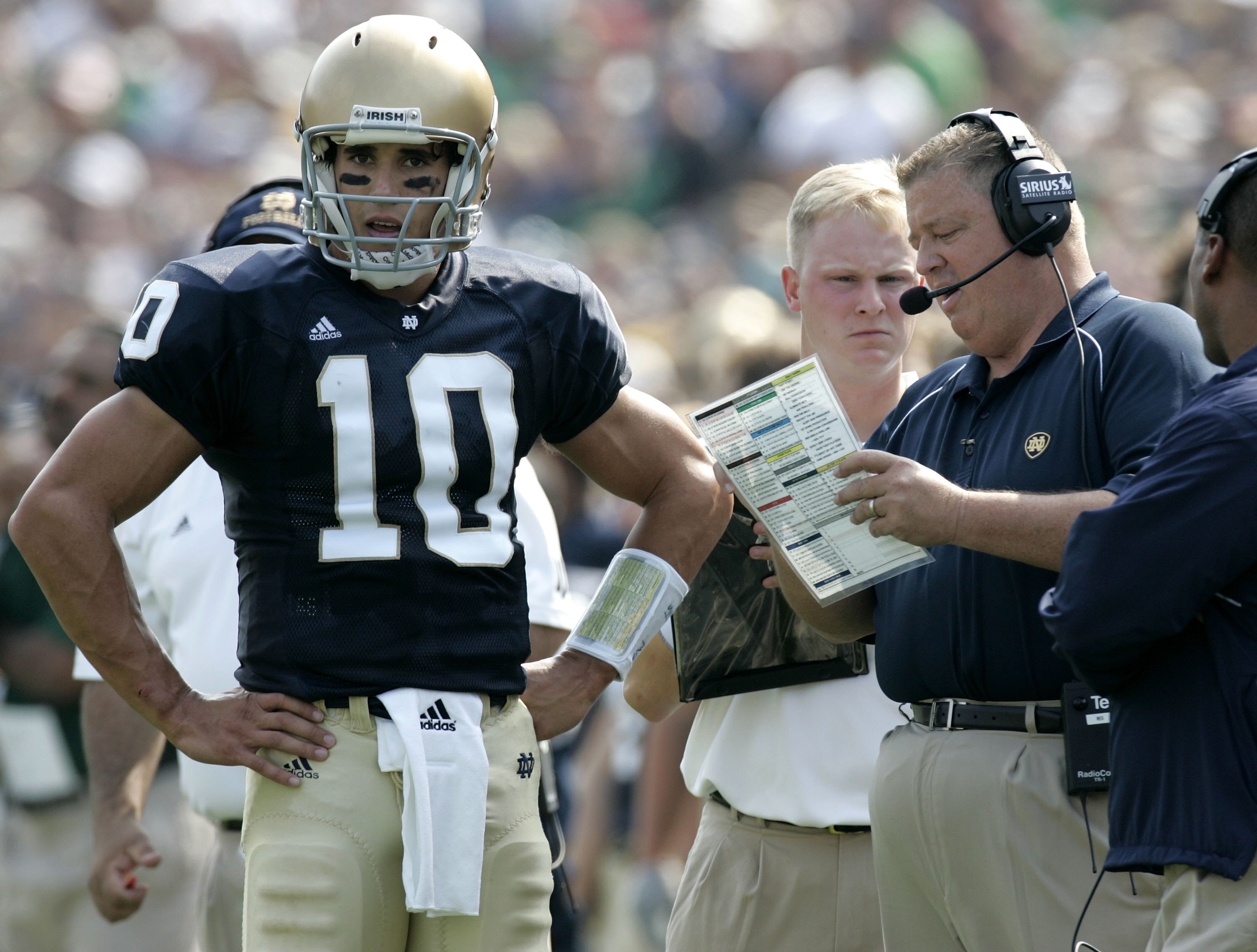 SOUTH BEND, IN - SEPTEMBER 9:  Brady Quinn #10 of the Notre Dame Fighting Irish talks with head coach Charlie Weis during a game against the Penn State Nittany Lions on September 9, 2006 at Notre Dame Stadium in South Bend, Indiana. Notre Dame won the gam