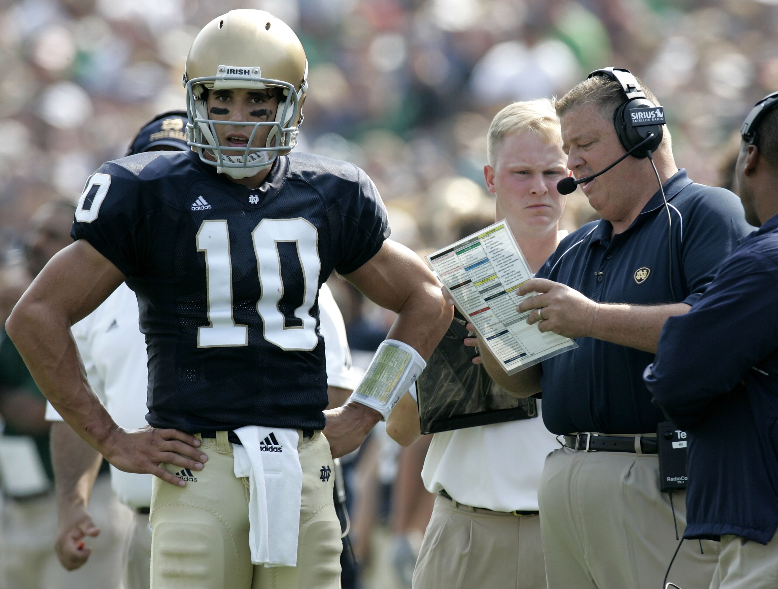 SOUTH BEND, IN - SEPTEMBER 9: Brady Quinn #10 of the Notre Dame Fighting Irish talks with head coach Charlie Weis during a game against the Penn State Nittany Lions on September 9, 2006 at Notre Dame Stadium in South Bend, Indiana. Notre Dame won the gam SOUTH BEND, IN - SEPTEMBER 9: Brady Quinn #10 of the Notre Dame Fighting Irish talks with head coach Charlie Weis during a game against the Penn State Nittany Lions on September 9, 2006 at Notre Dame Stadium in South Bend, Indiana. Notre Dame won the gam