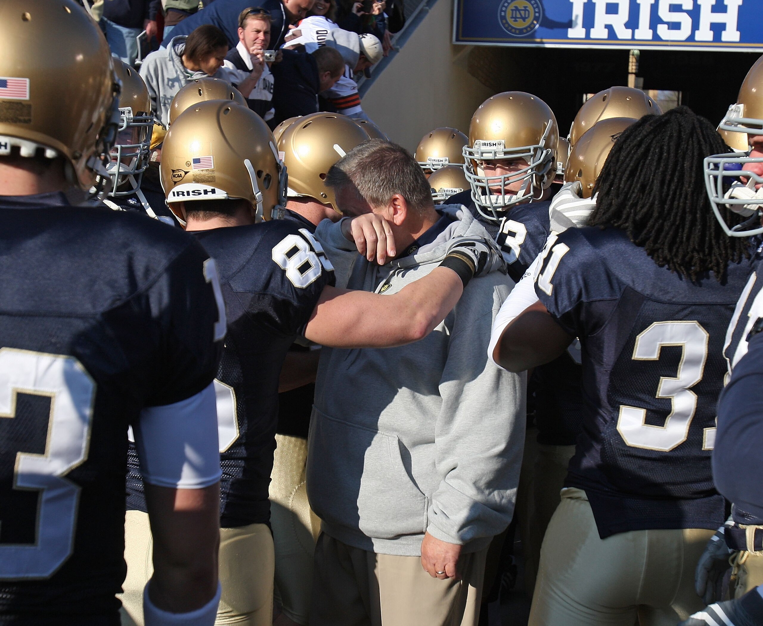 SOUTH BEND, IN - NOVEMBER 21: Head coach Charlie Weis of the Notre Dame Fighting Irish wipes a tear from his eye before lining up to enter the field for a game against the University of Connecticut Huskies at Notre Dame Stadium on November 21, 2009 in Sou SOUTH BEND, IN - NOVEMBER 21: Head coach Charlie Weis of the Notre Dame Fighting Irish wipes a tear from his eye before lining up to enter the field for a game against the University of Connecticut Huskies at Notre Dame Stadium on November 21, 2009 in Sou