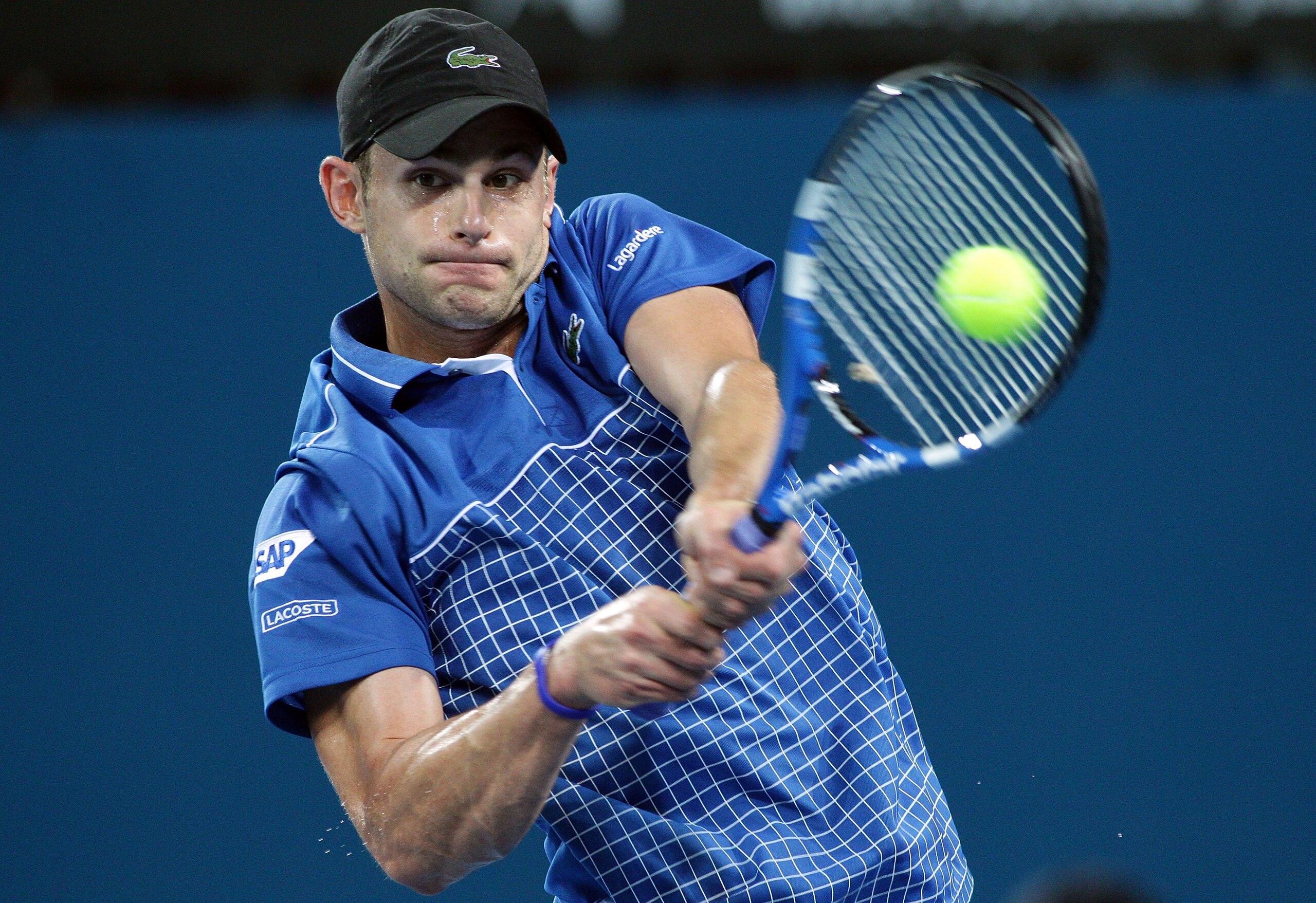 BRISBANE, AUSTRALIA - JANUARY 03:  Andy Roddick of the USA plays a backhand during his first round match against Marinko Matosevic of Australia during day two of the Brisbane International at Queensland Tennis Centre on January 3, 2011 in Brisbane, Austra