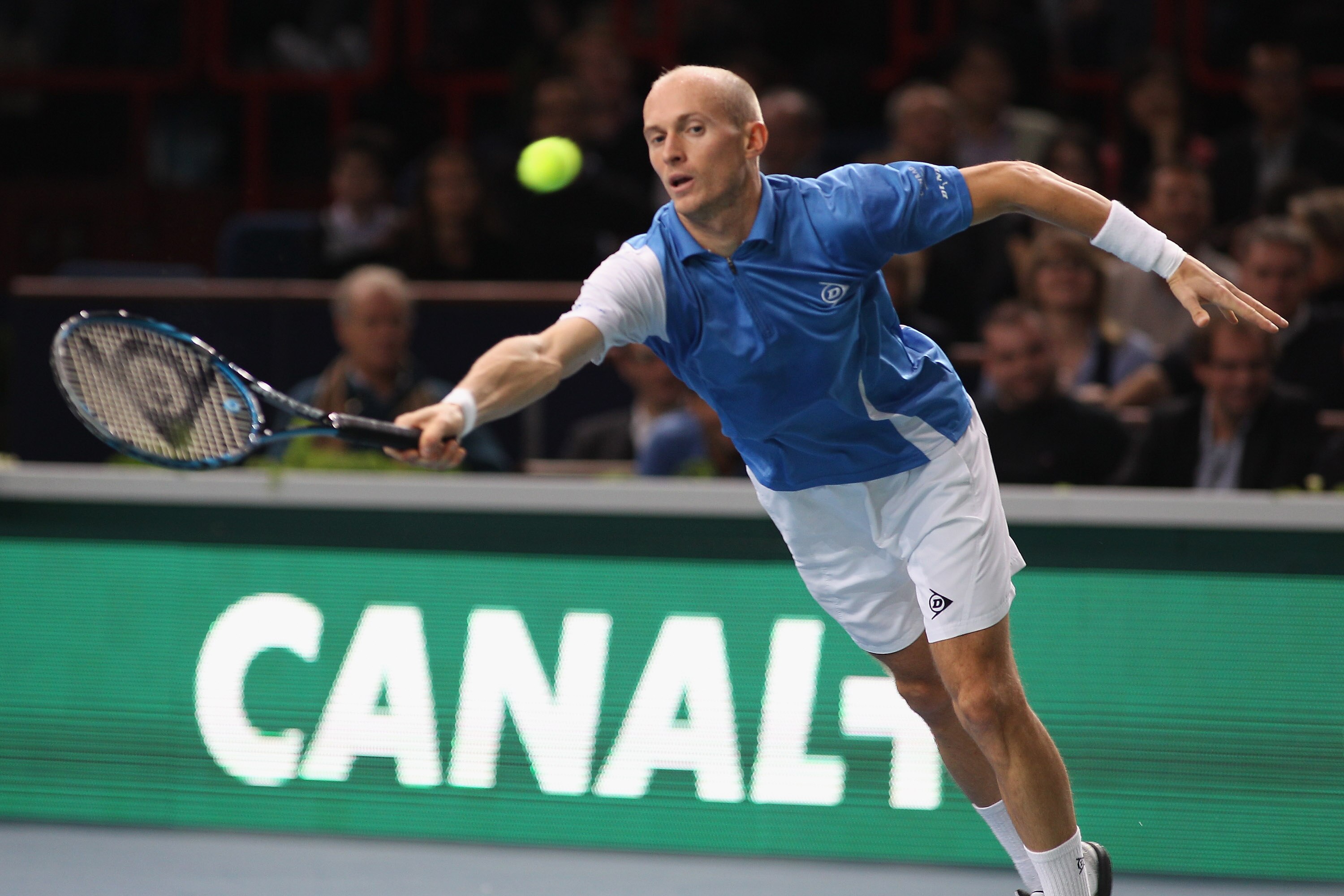 PARIS - NOVEMBER 12: Nikolay Davydenko of Russia  in action during his quarter-final match against  Michael llodra of France during Day Six of the ATP Masters Series Paris at the Palais Omnisports  on November 12, 2010 in Paris, France.  (Photo by Michael