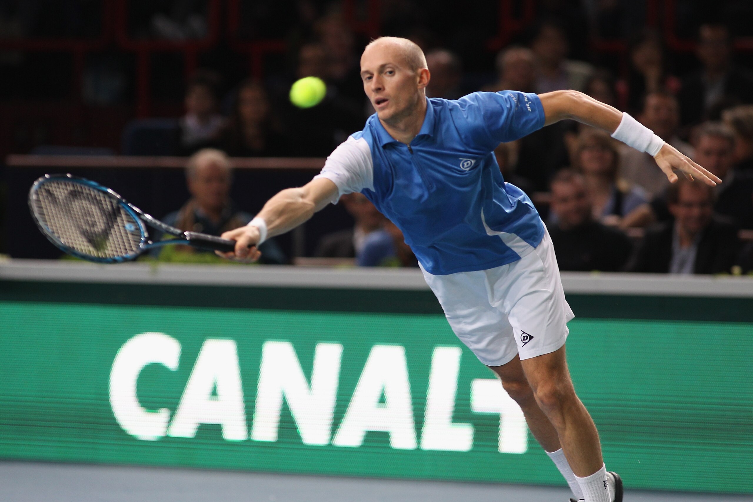PARIS - NOVEMBER 12: Nikolay Davydenko of Russia  in action during his quarter-final match against  Michael llodra of France during Day Six of the ATP Masters Series Paris at the Palais Omnisports  on November 12, 2010 in Paris, France.  (Photo by Michael