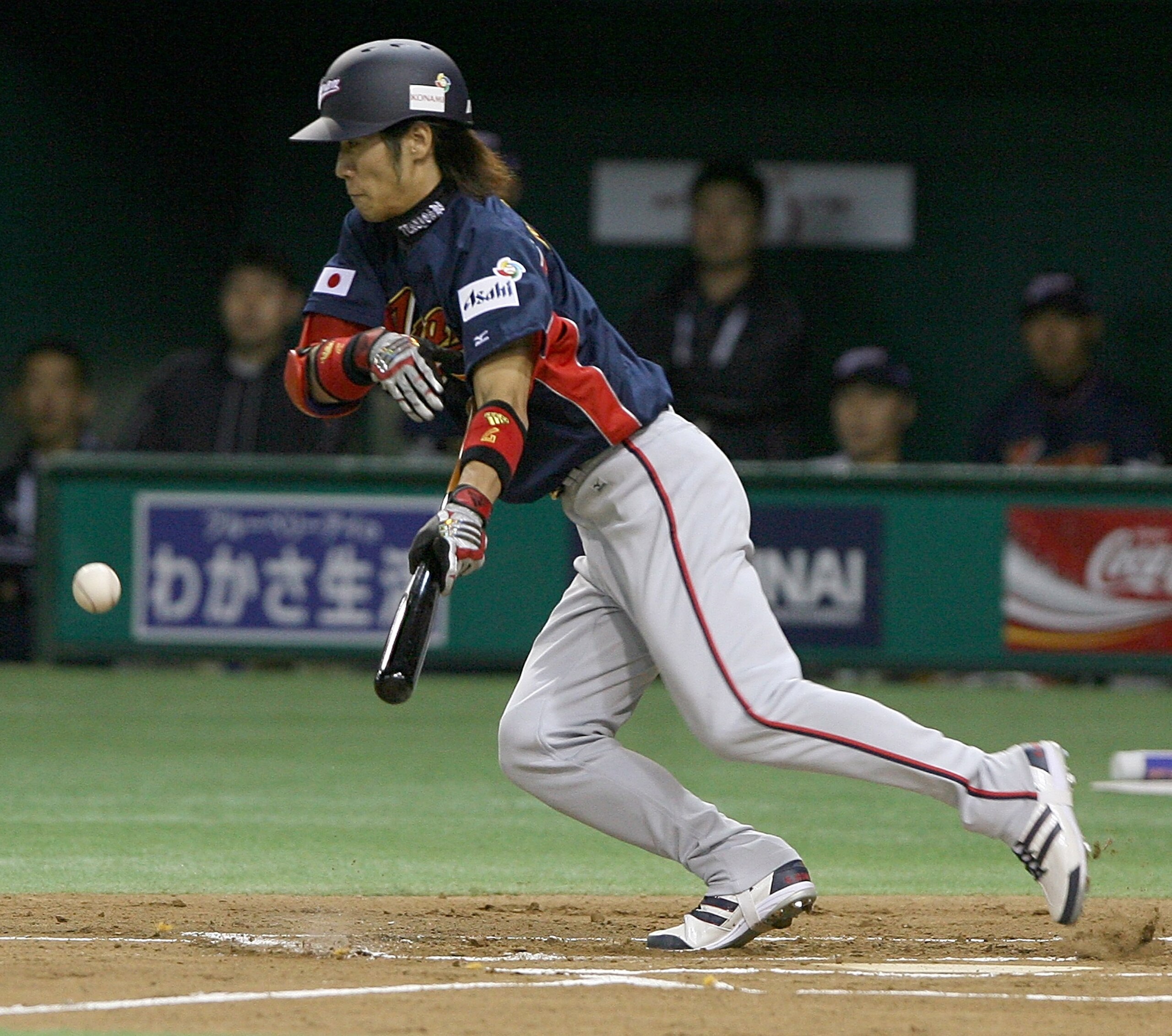 TOKYO, JAPAN - MARCH 3:  Infielder Tsuyoshi Nishioka #7 of Japan lays down a bunt during the first round match between Japan and China of the 2006 World Baseball Classic at the Tokyo Dome on March 3, 2006 in Tokyo, Japan.  (Photo by Koichi Kamoshida/Getty