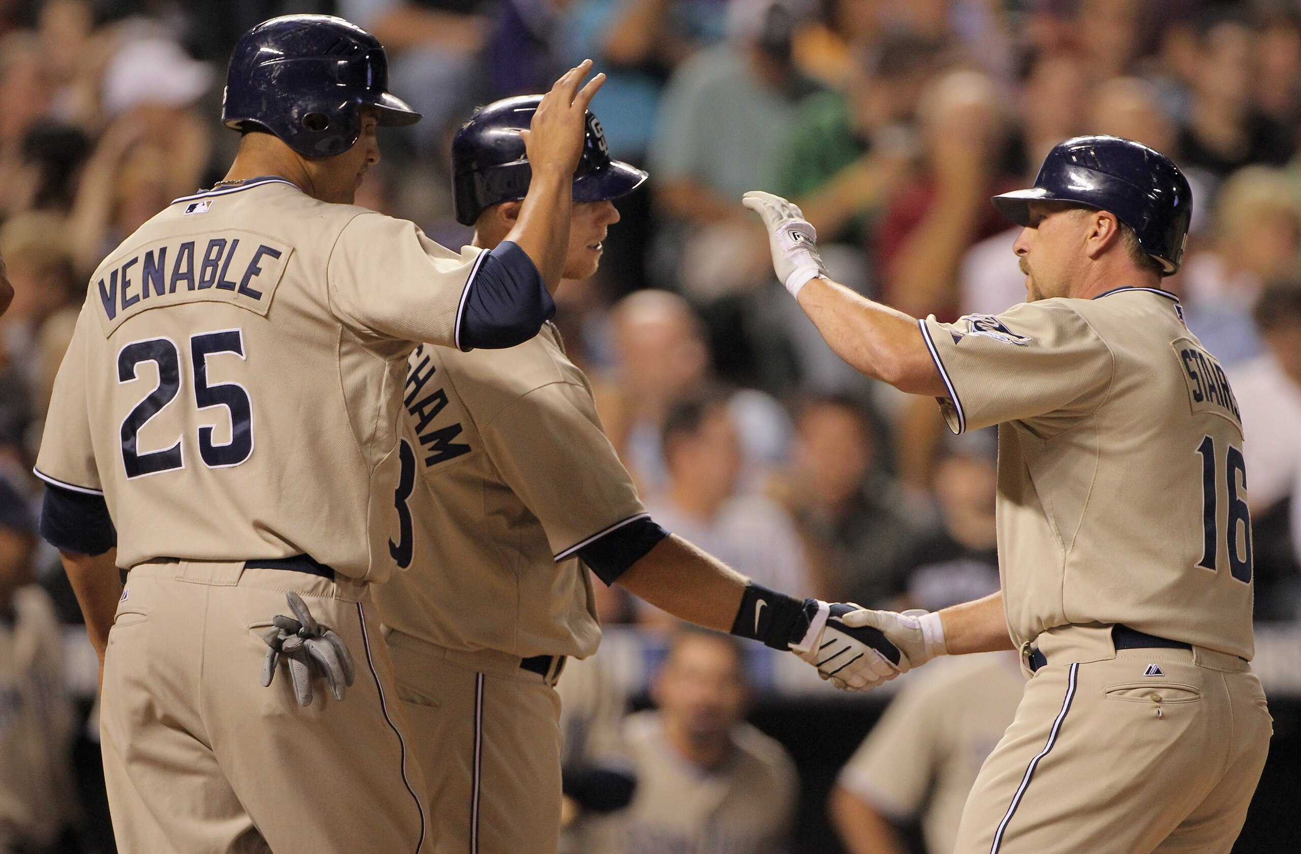 DENVER - SEPTEMBER 14:  Matt Stairs #16 of the San Diego Padres is welcomed home by Will Venable #25, who scored on the play, and Aaron Cunningham #28 after Stairs' two run pinch hit home run off of Rafael Betancourt of the Colorado Rockies in the eighth