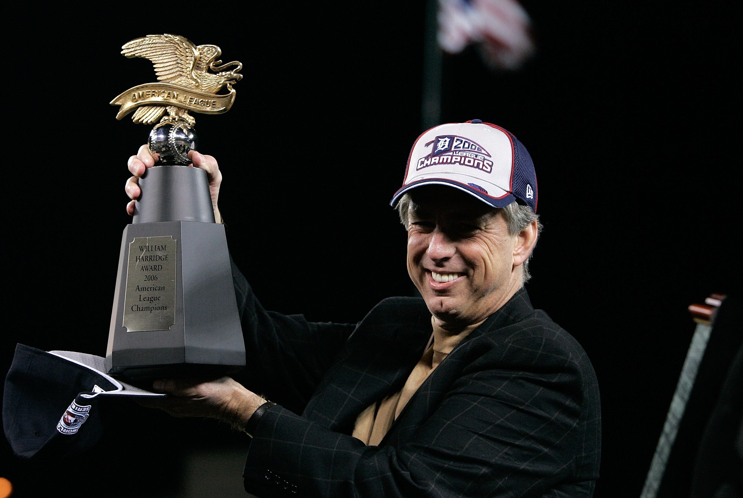DETROIT - OCTOBER 14:  General Manager Dave Dombrowski of the Detroit Tigers holds the AMerican Championship Trophy after the Tigers won 6-3 against the Oakland Athletics during Game Four of the American League Championship Series October 14, 2006 at Come