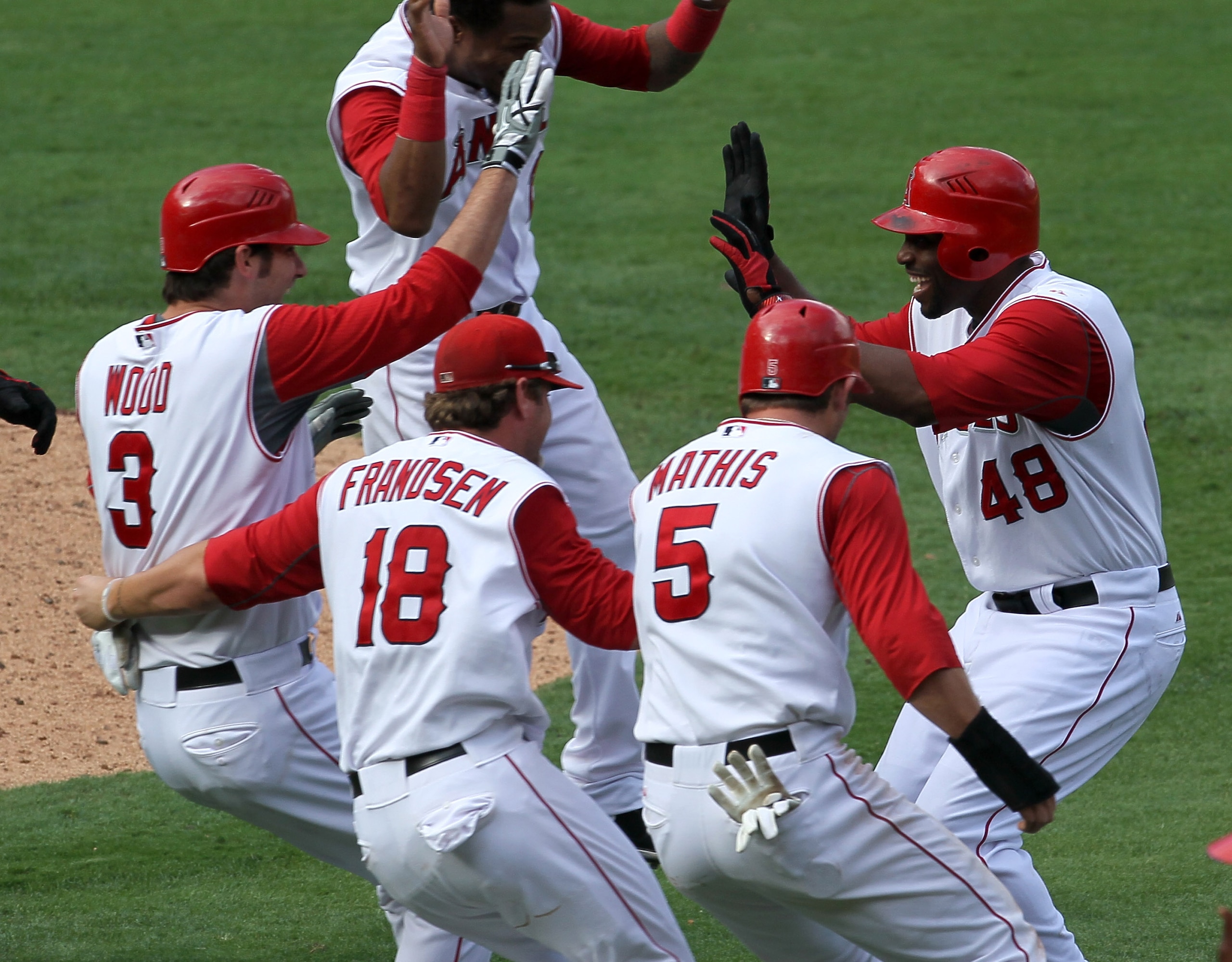 ANAHEIM, CA - SEPTEMBER 29:  Torii Hunter #48 of the Los Angeles Angels of Anaheim is mobbed by Brandon Wood #3, Kevin Frandsen #18, and Jeff Mathis #5 after Hunter's walk off single in the 11th inning ended the game with the Oakland Athletics on Septembe