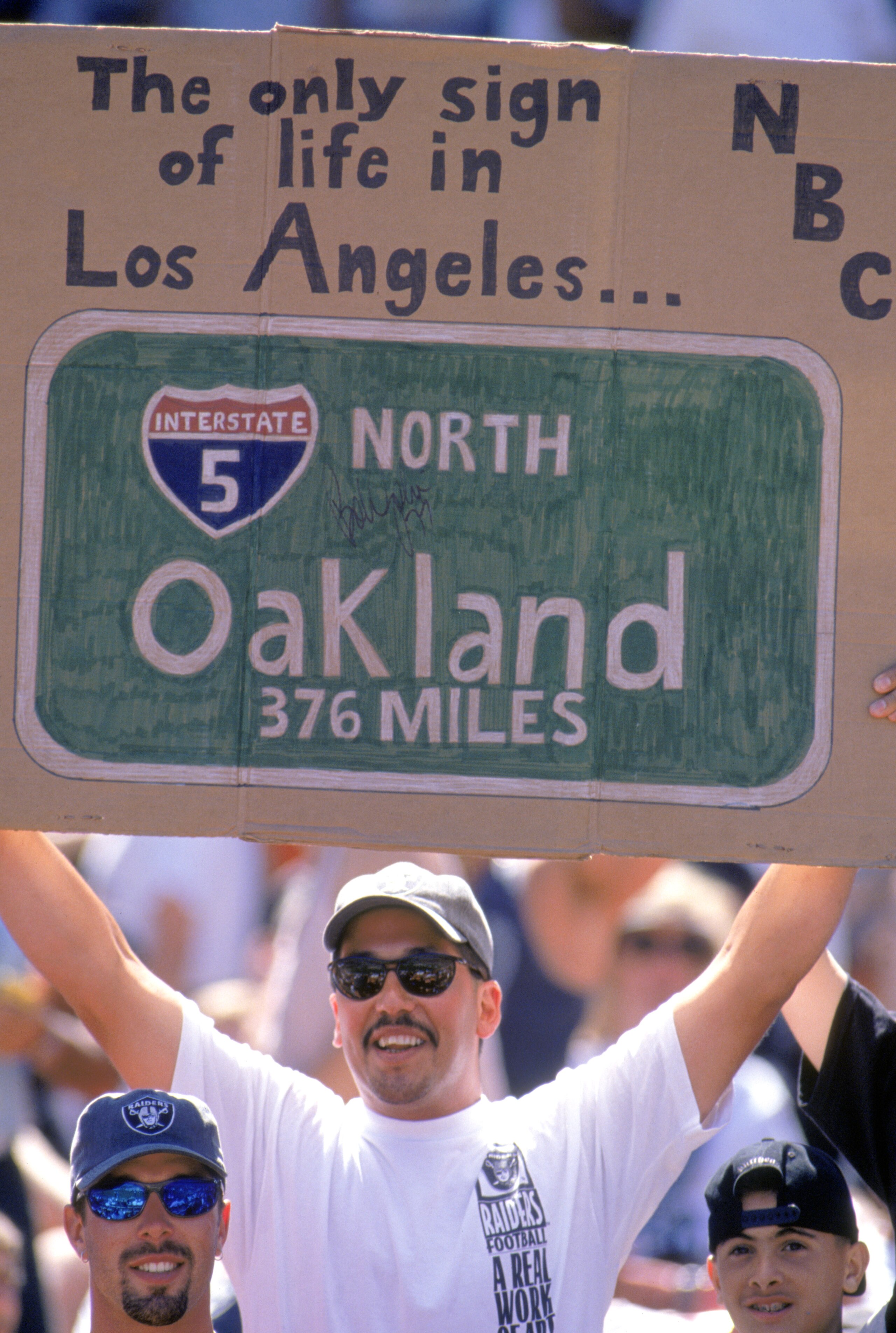 OAKLAND, CA - SEPTEMBER 3: A fan supports Oakland Raiders during the game against the San Diego Chargers on September 3, 1995, at the Oakland Coliseum in Oakland, California. The Raiders won 17-7. The Raiders moved to Oakland from Los Angeles this year, OAKLAND, CA - SEPTEMBER 3: A fan supports Oakland Raiders during the game against the San Diego Chargers on September 3, 1995, at the Oakland Coliseum in Oakland, California. The Raiders won 17-7. The Raiders moved to Oakland from Los Angeles this year,