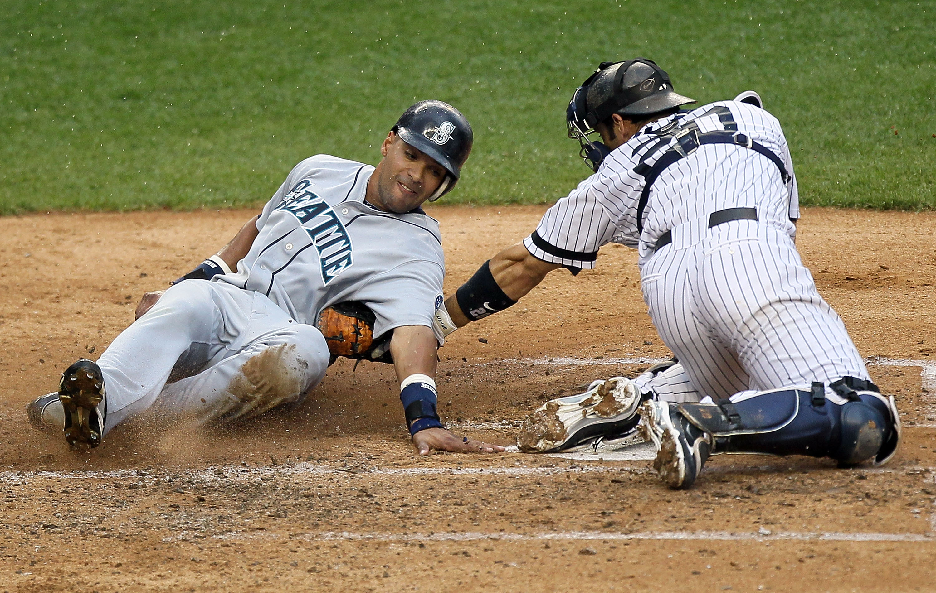 NEW YORK - AUGUST 22:  Franklin Gutierrez #21 of the Seattle Mariners is out at the plate on the tag from Jorge Posada #20 of the New York Yankees during the fifth inning on August 22, 2010 at Yankee Stadium in the Bronx borough of New York City.  (Photo