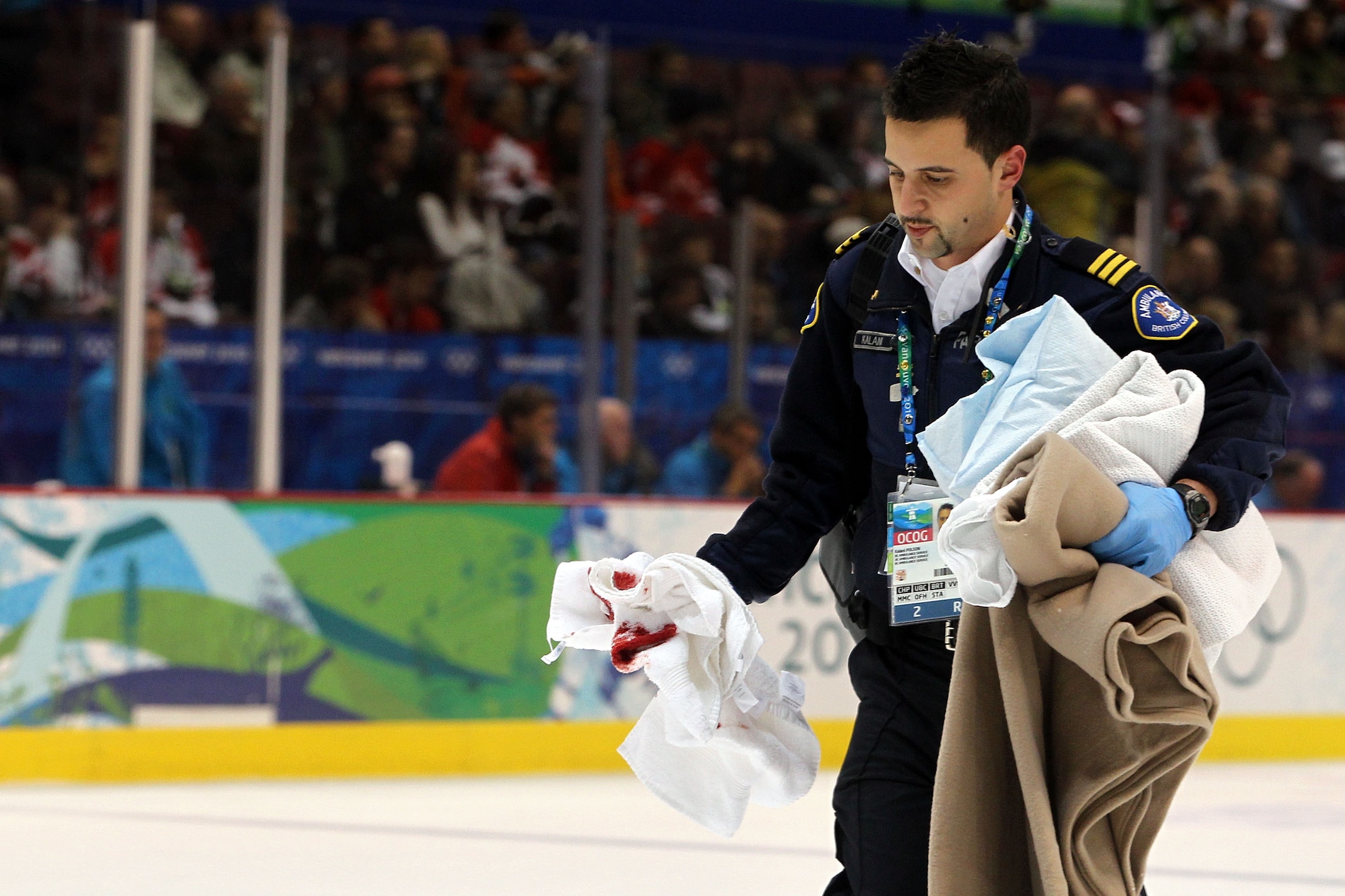 VANCOUVER, BC - FEBRUARY 23:  Medical personel walks of the ice with bloody rags after an injury to Lubos Bartecko #23 of Slovakia during the ice hockey Men's Qualification Playoff game between Norway and Slovakia on day 12 of the Vancouver 2010 Winter Ol