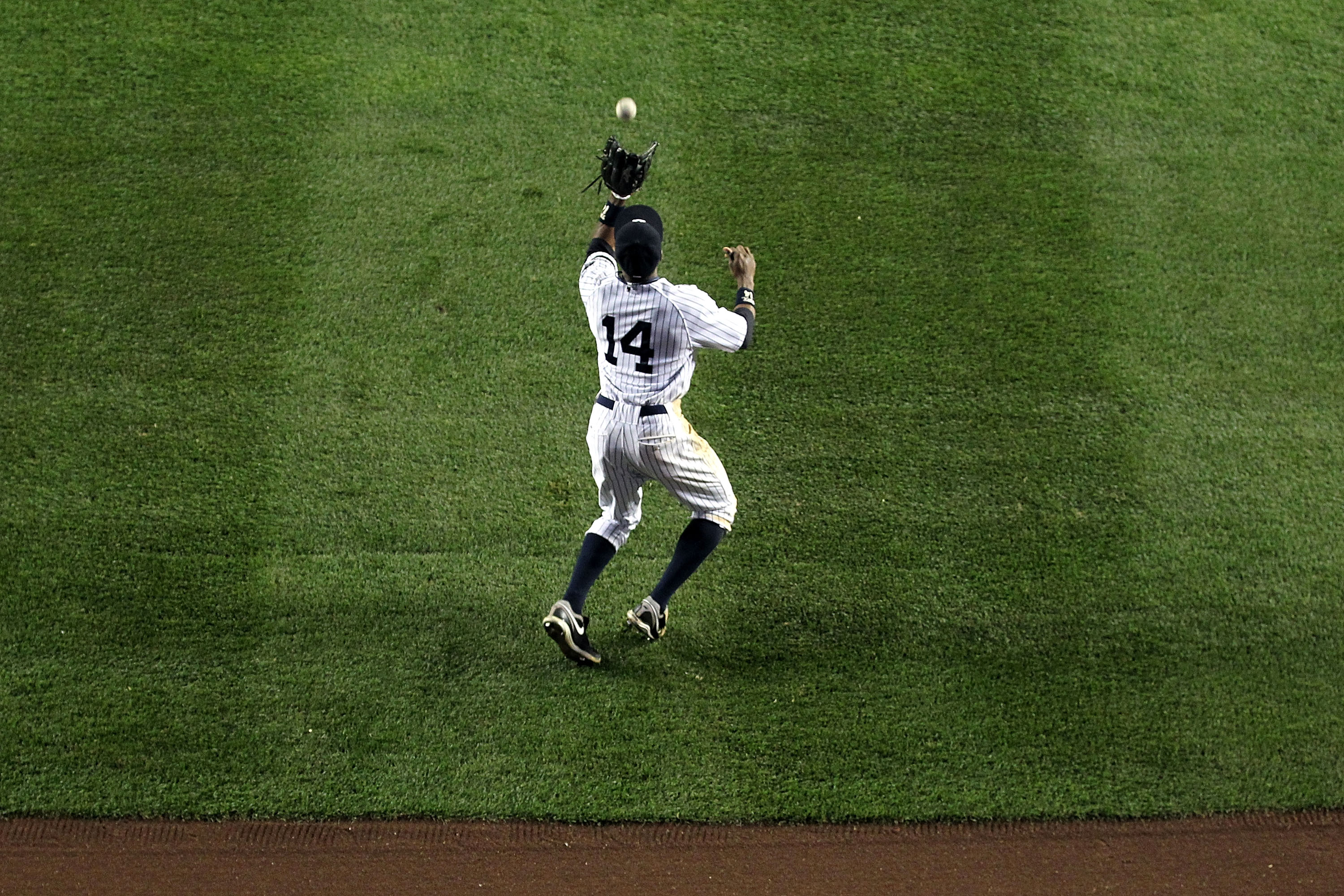 NEW YORK - OCTOBER 19:  Curtis Granderson #14 of the New York Yankees catches a fly ball in centerfield against the Texas Rangers in Game Four of the ALCS during the 2010 MLB Playoffs at Yankee Stadium on October 19, 2010 in the Bronx borough of New York