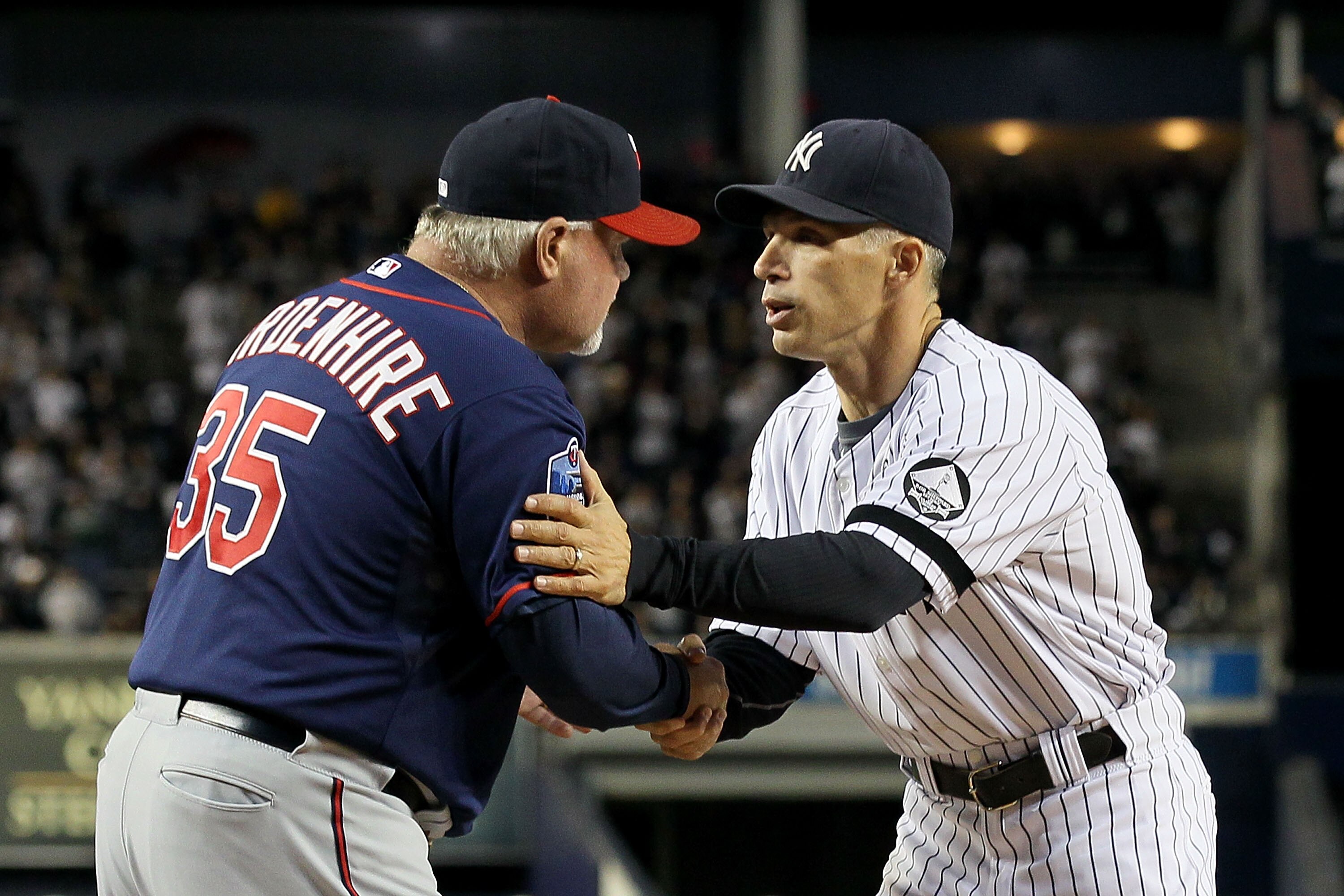 NEW YORK - OCTOBER 09:  Manager Joe Girardi #28 (R) of the New York Yankees greets manager Ron Gardenhire #35 of the Minnesota Twins prior to Game Three of the ALDS part of the 2010 MLB Playoffs at Yankee Stadium on October 9, 2010 in the Bronx borough of