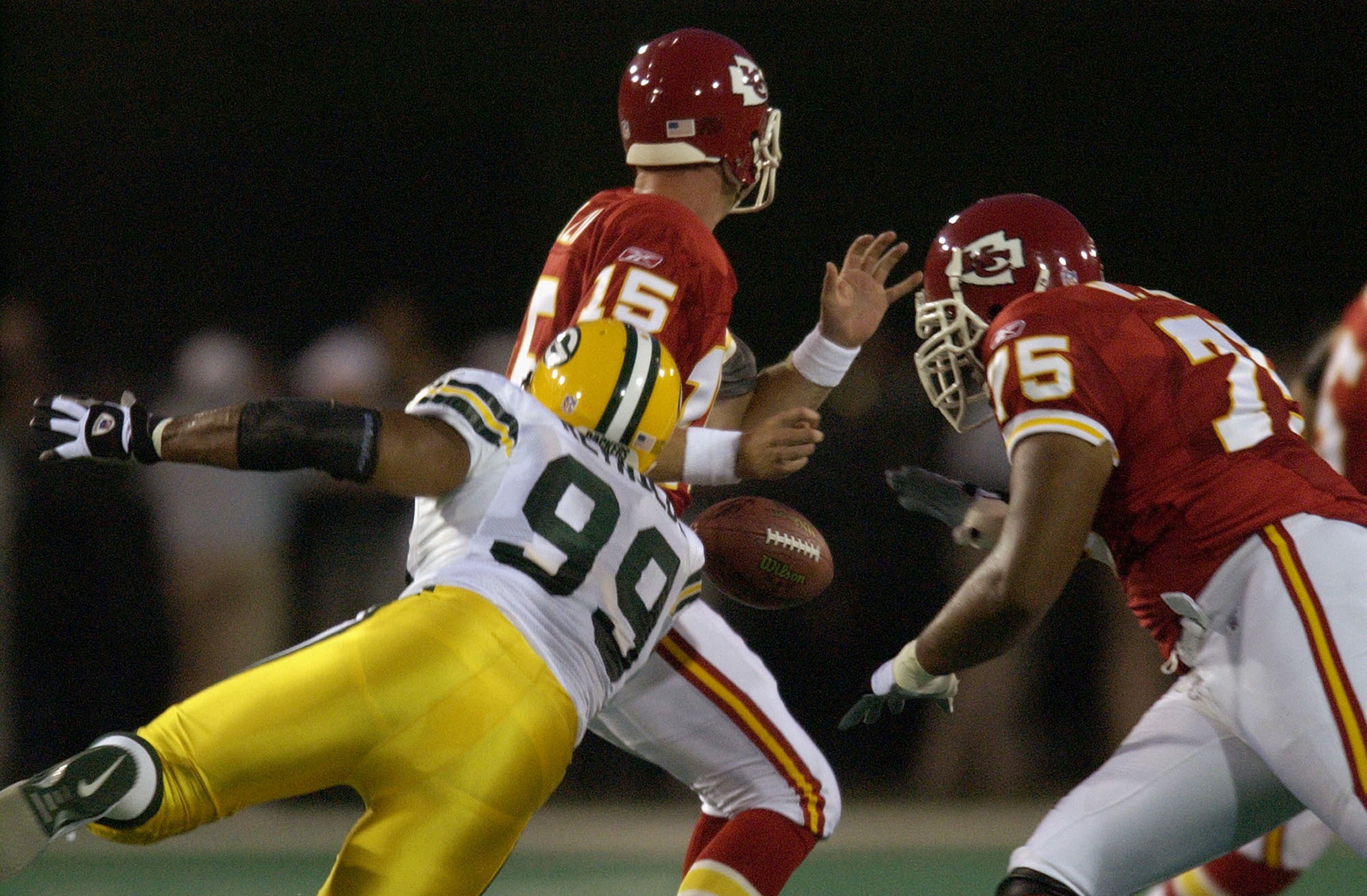 CANTON, OH - AUGUST 4:  Quarterback Todd Collins #15 of the Kansas City Chiefs fumbles as he is hit by defensive end Jamal Reynolds #99 of the Green Bay Packers during the Hall of Fame game at Fawcett Stadium on August 4, 2003 in Canton, Ohio.  The Chiefs