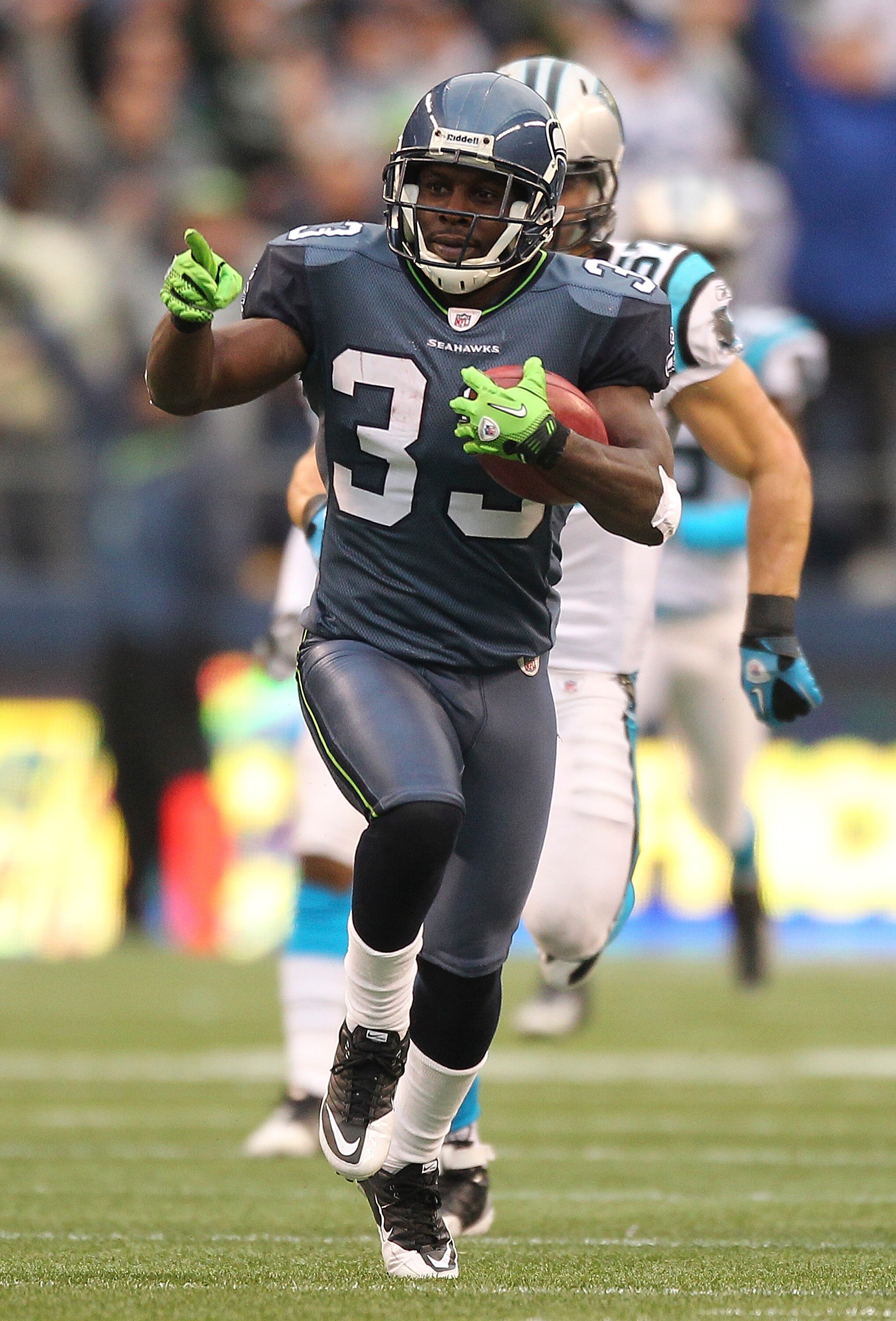 SEATTLE, WA - DECEMBER 05:  Running back Leon Washington #33 of the Seattle Seahawks returns a punt for 84 yards against the Carolina Panthers at Qwest Field on December 5, 2010 in Seattle, Washington. Washington was down at the 2 yard line on the play, a