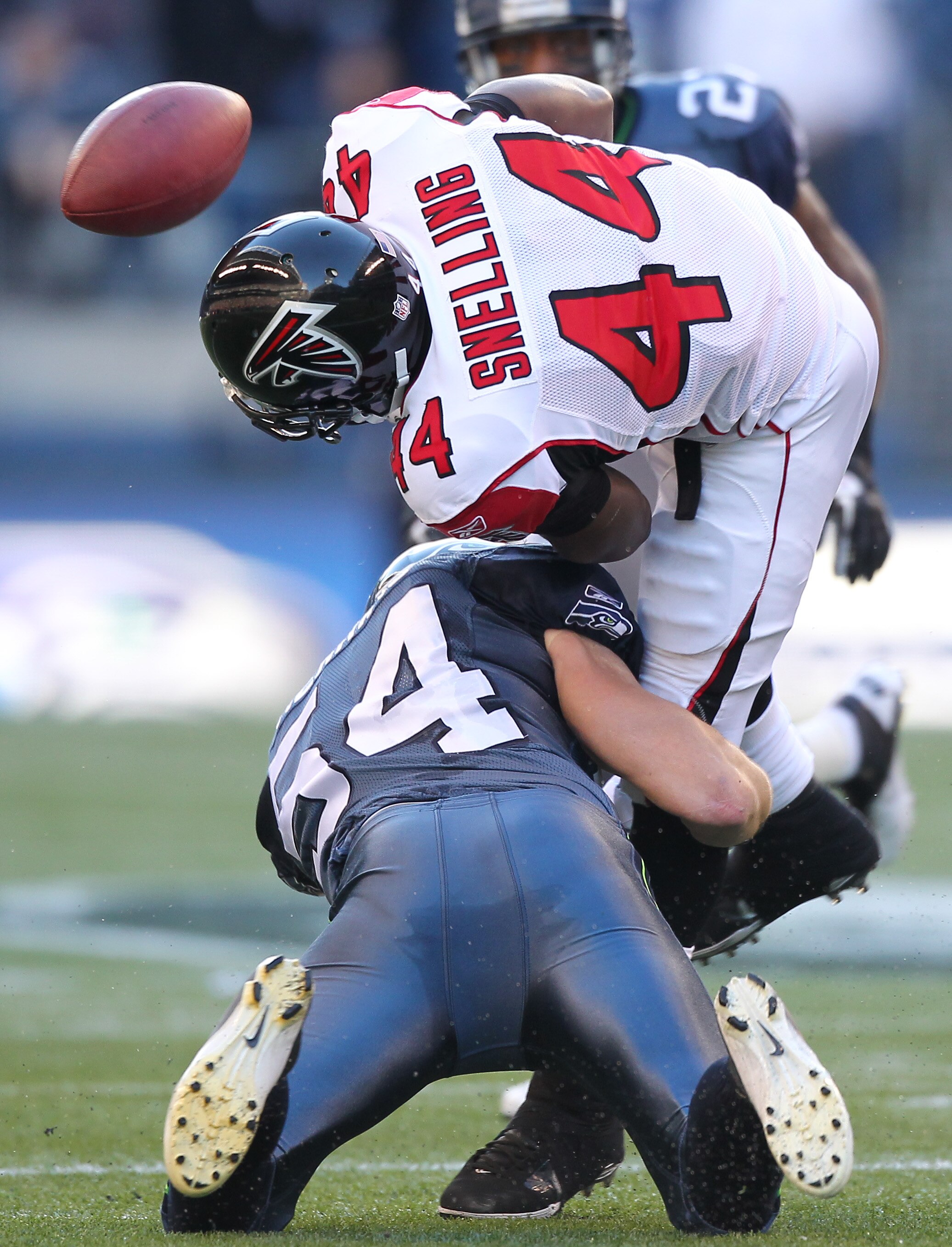SEATTLE, WA - DECEMBER 19:  Running back Jason Snelling #44 of the Atlanta Falcons fumbles as he is tackled by Will Herring #54 of the Seattle Seahawks at Qwest Field on December 19, 2010 in Seattle, Washington. The Falcons defeated the Seahawks 34-18. (P