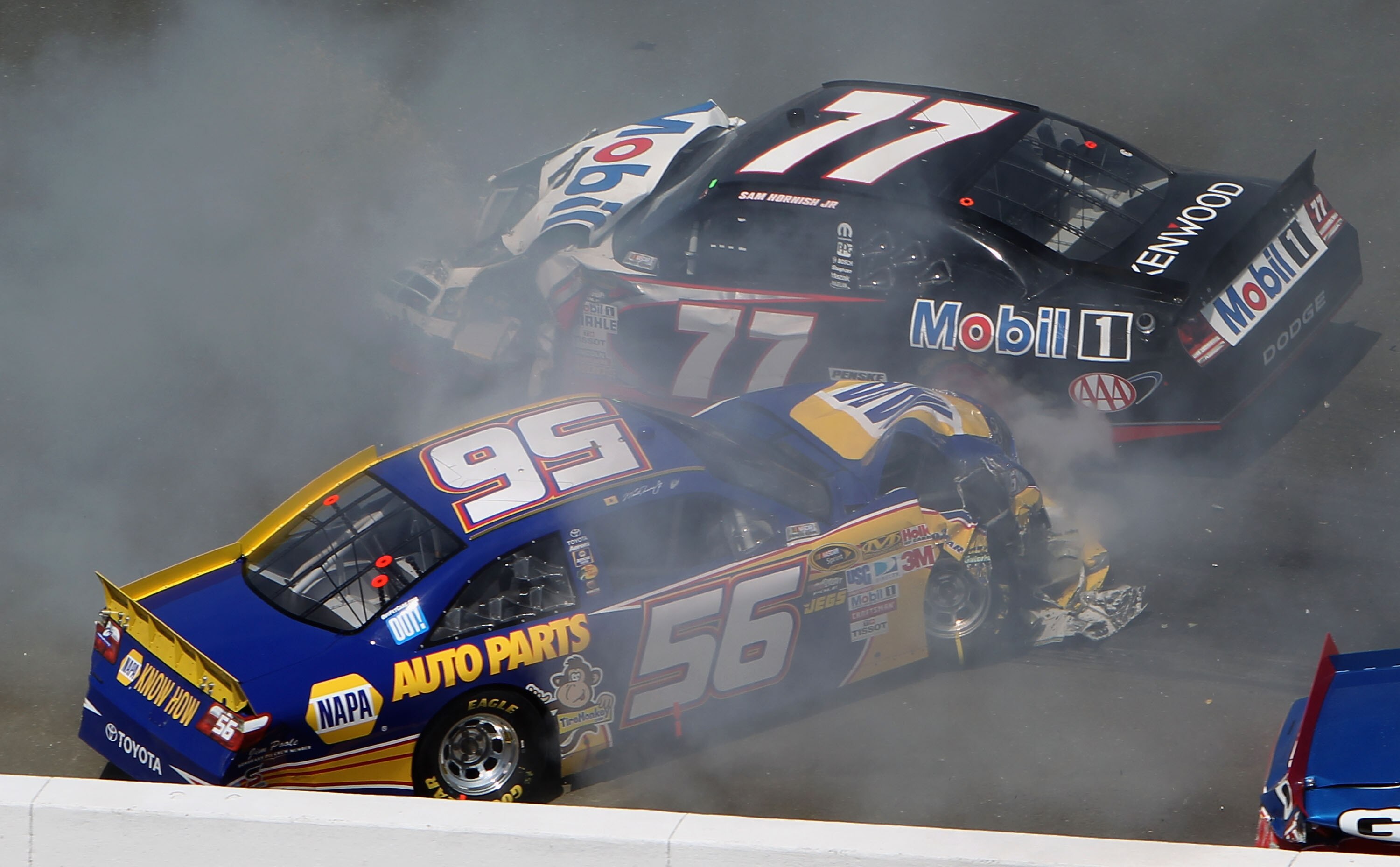 SONOMA, CA - JUNE 20:  Martin Truex Jr., driver of the #56 NAPA Toyota, and Sam Hornish Jr., driver of the #77 Mobil 1 Dodge, crash during a restart in the NASCAR Sprint Cup Series Toyota/Save Mart 350 at Infineon Raceway on June 20, 2010 in Sonoma, Calif