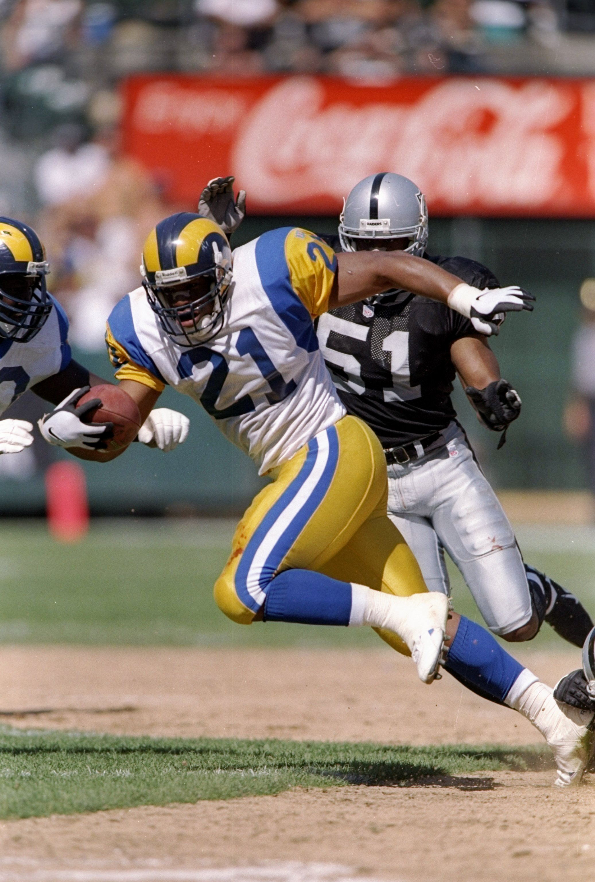 28 Sep 1997:  Running back Lawrence Phillips #21 of the St. Louis Rams carries the football during the Rams 35-17 loss to the Oakland Raiders at UMAX Stadium in Oakland, California. Mandatory Credit: Todd Warshaw  /Allsport