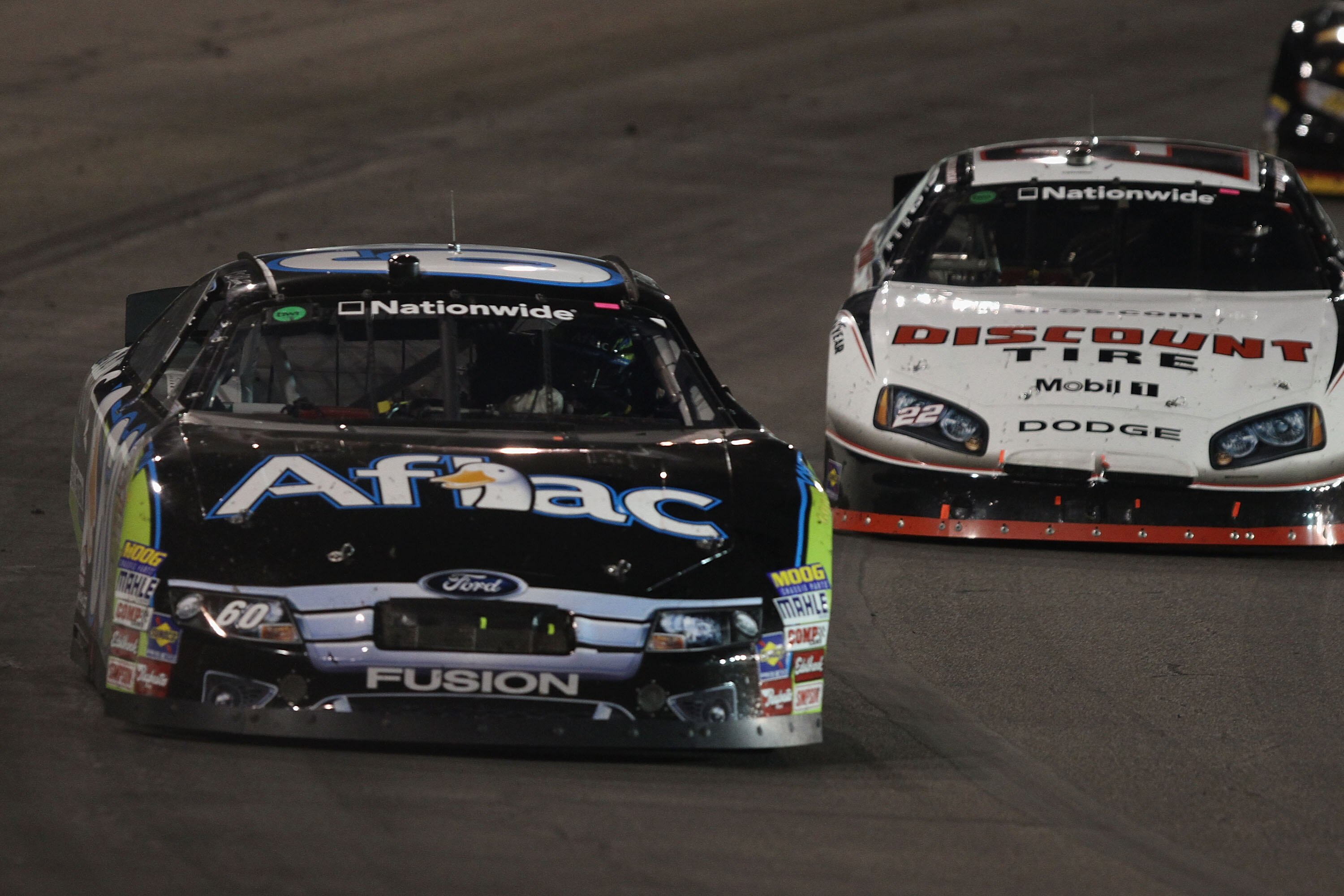 MADISON, IL - JULY 17: Carl Edwards, driver of the #60 Aflac Ford, leads Brad Keselowski driver of the #22 Discount Tire Dodge into turn three during the NASCAR Nationwide Series Missouri-Illinois Dodge Dealers 250 at Gateway International Raceway on July