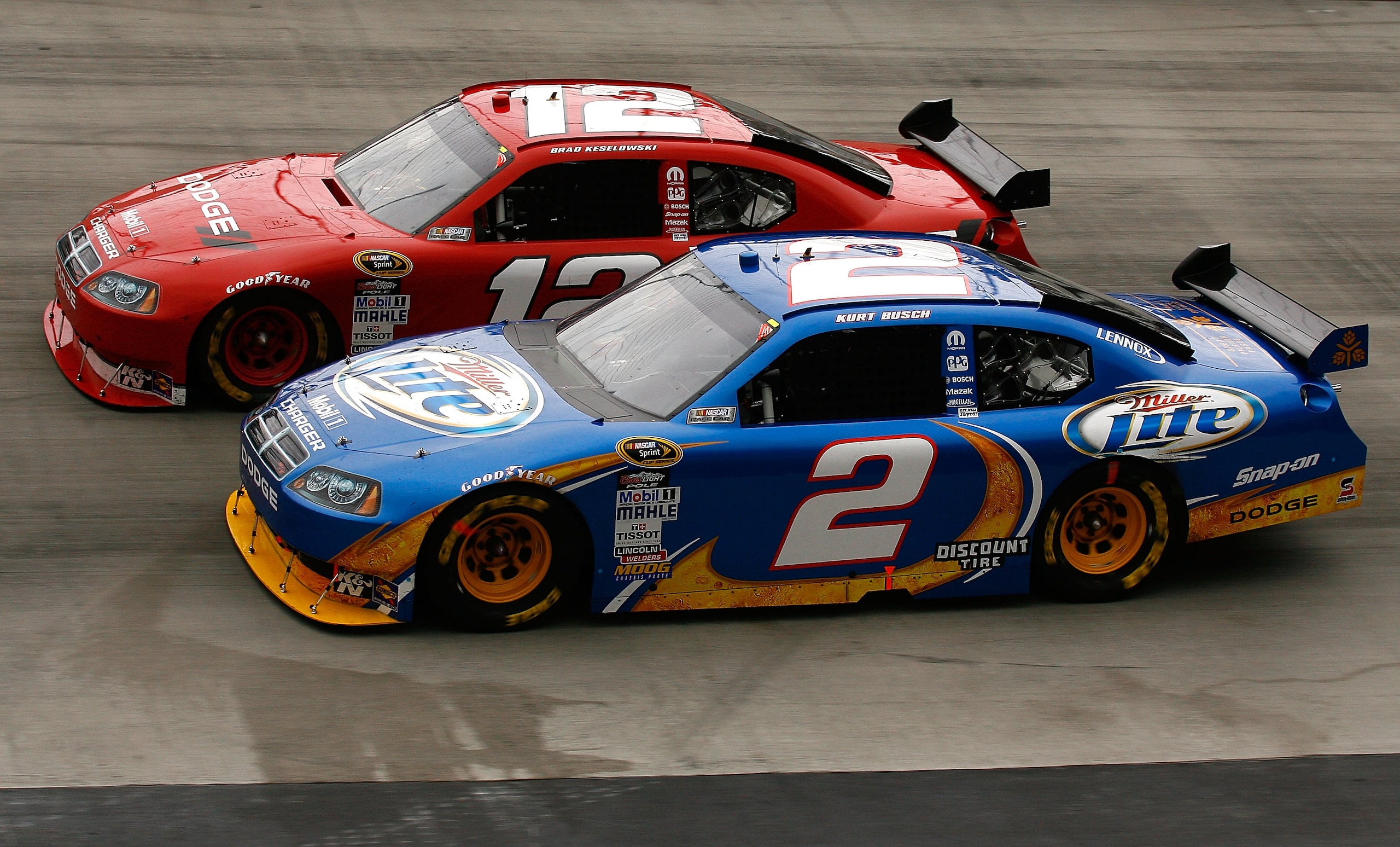 BRISTOL, TN - MARCH 21:  Kurt Busch, driver of the #2 Miller Lite Dodge races Brad Keselowski, driver of the #12 Dodge during the NASCAR Sprint Cup Series Food City 500 at Bristol Motor Speedway on March 21, 2010 in Bristol, Tennessee.  (Photo by Jason Sm