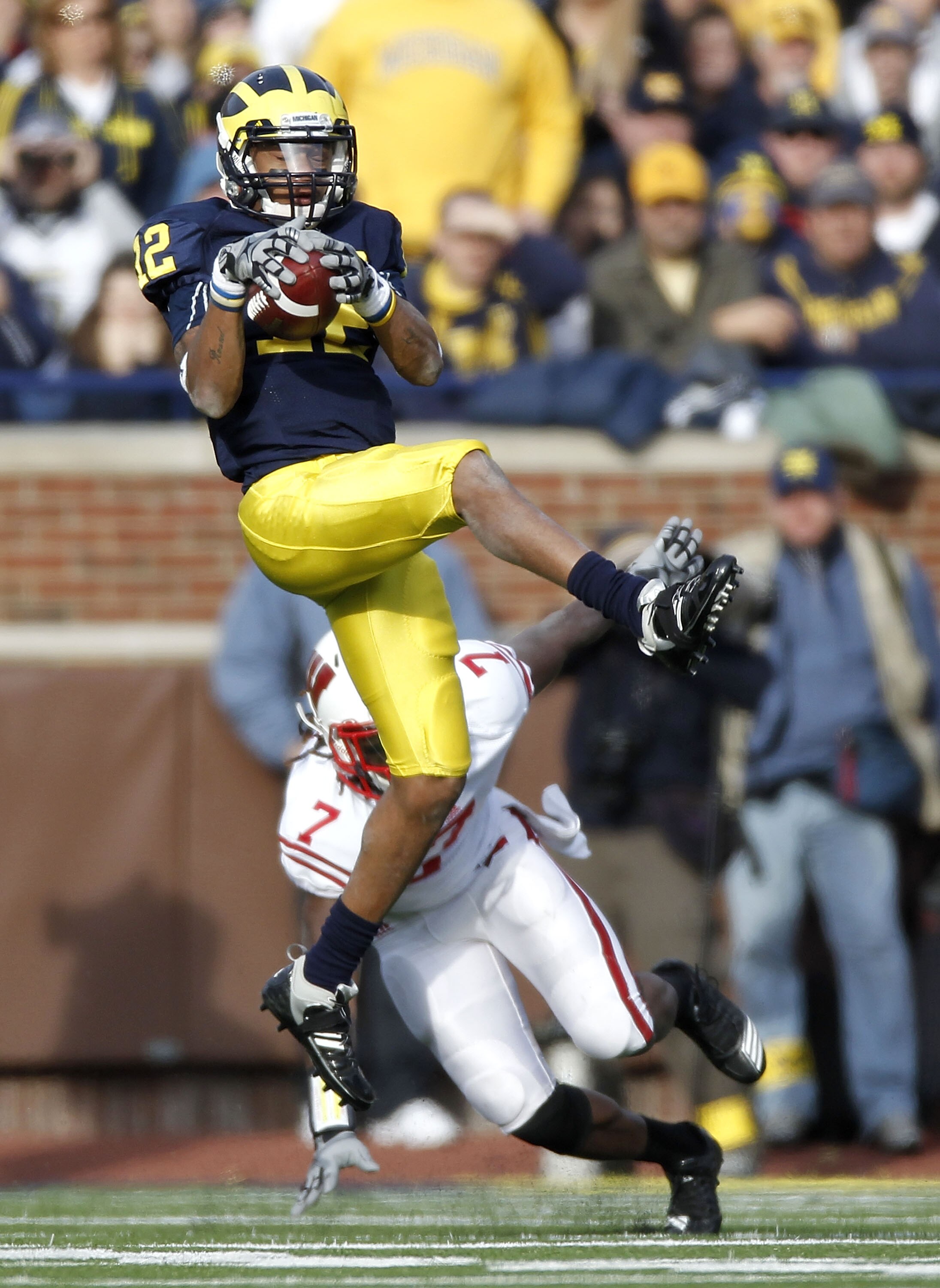 ANN ARBOR, MI - NOVEMBER 20:  Roy Roundtree #12 of the Michigan Wolverines catches a fourth quarter pass in front of Aaron Henry #7 of the Wisconsin Badgers at Michigan Stadium on November 20, 2010 in Ann Arbor, Michigan. Wisconson won the game 48-28.  (P