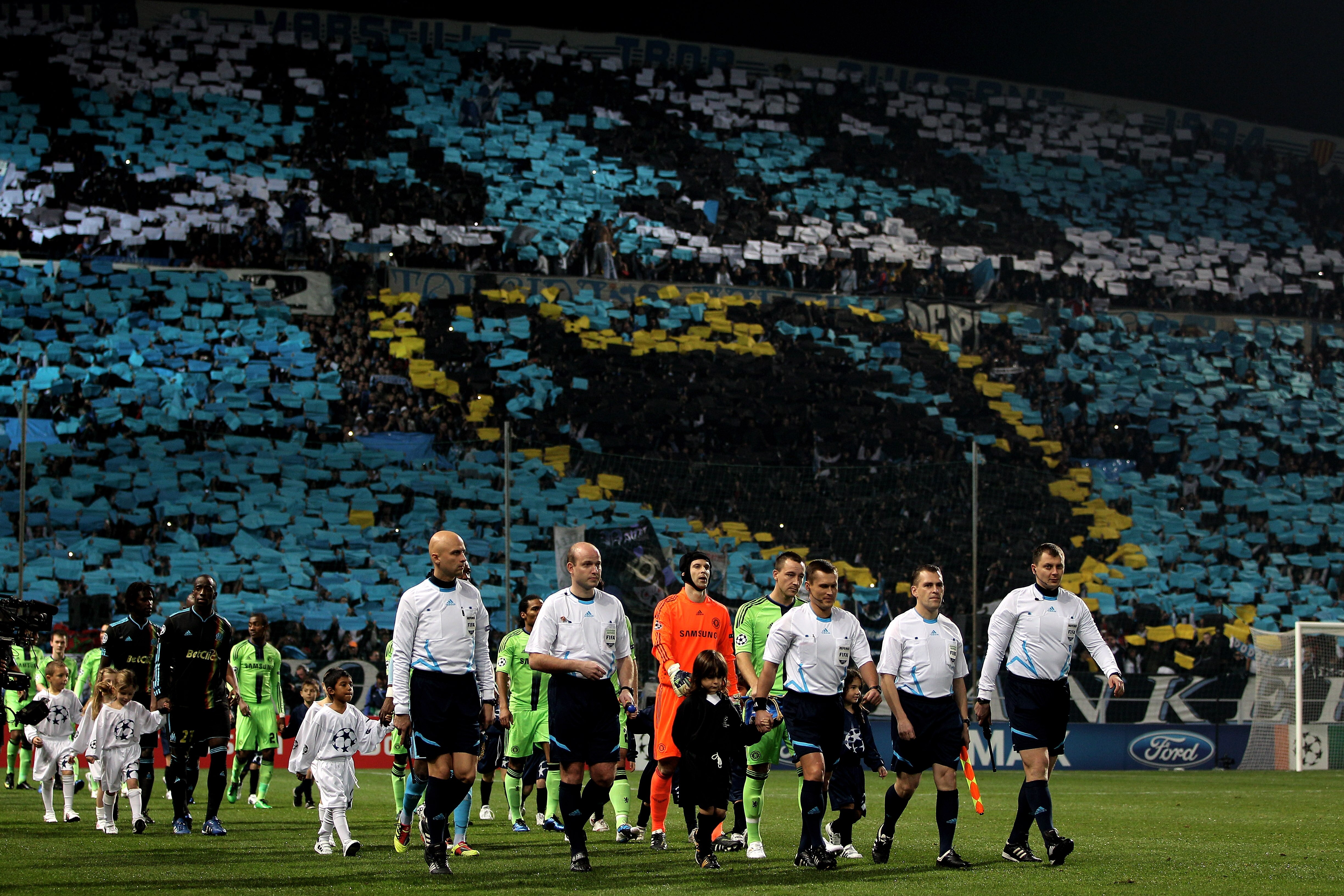 MARSEILLE, FRANCE - DECEMBER 08:  The officials lead ou the teams prior to kickoff during the UEFA Champions League Group F match between Marseille and Chelsea at the Stade Velodrome on December 8, 2010 in Marseille, France.  (Photo by Michael Steele/Gett