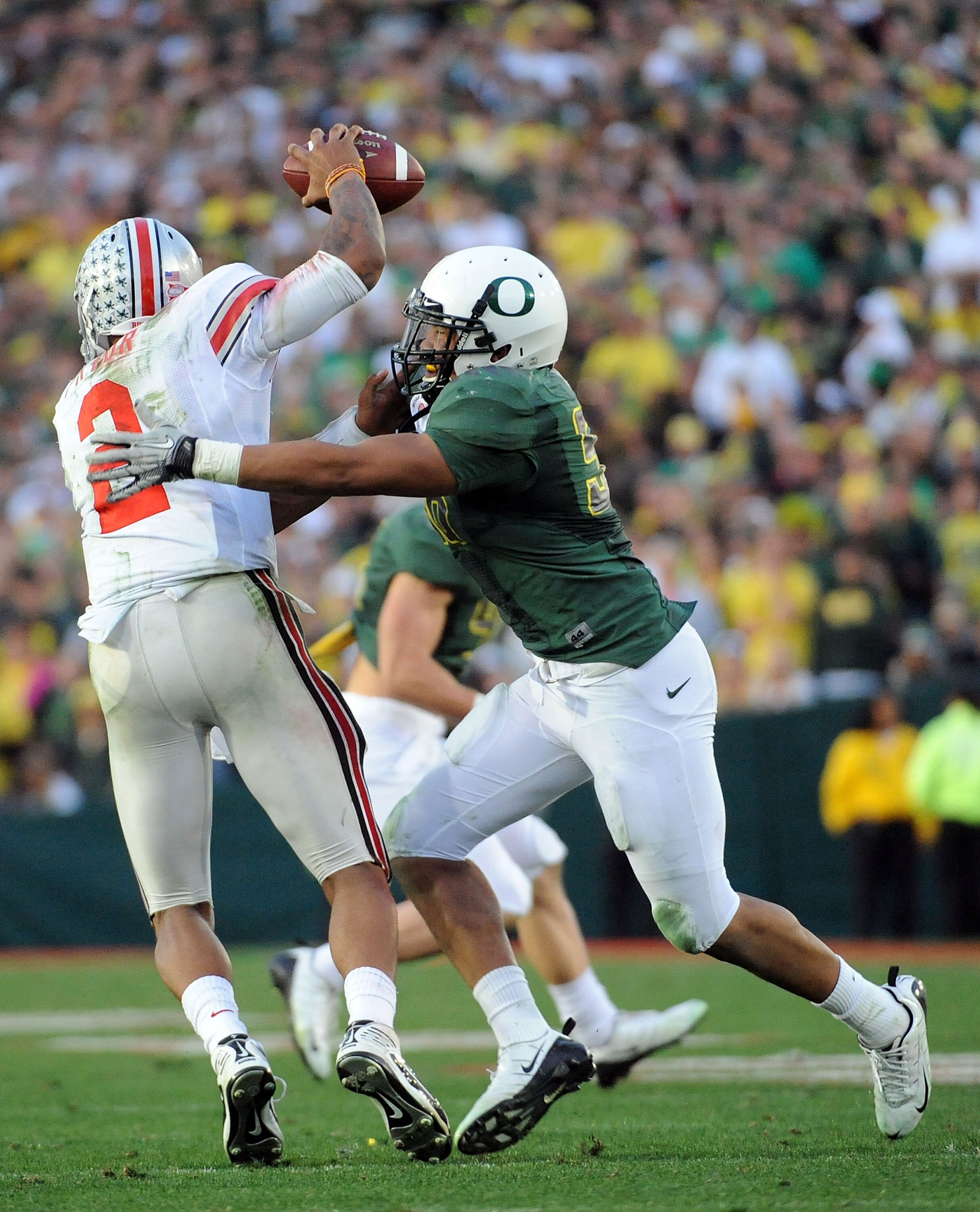 PASADENA, CA - JANUARY 01:  Linebacker Kenny Rowe #58 of the Oregon Ducks sacks Terrelle Pryor #2 of the Ohio State Buckeyes in the second half at the 96th Rose Bowl game on January 1, 2010 in Pasadena, California.  (Photo by Harry How/Getty Images)