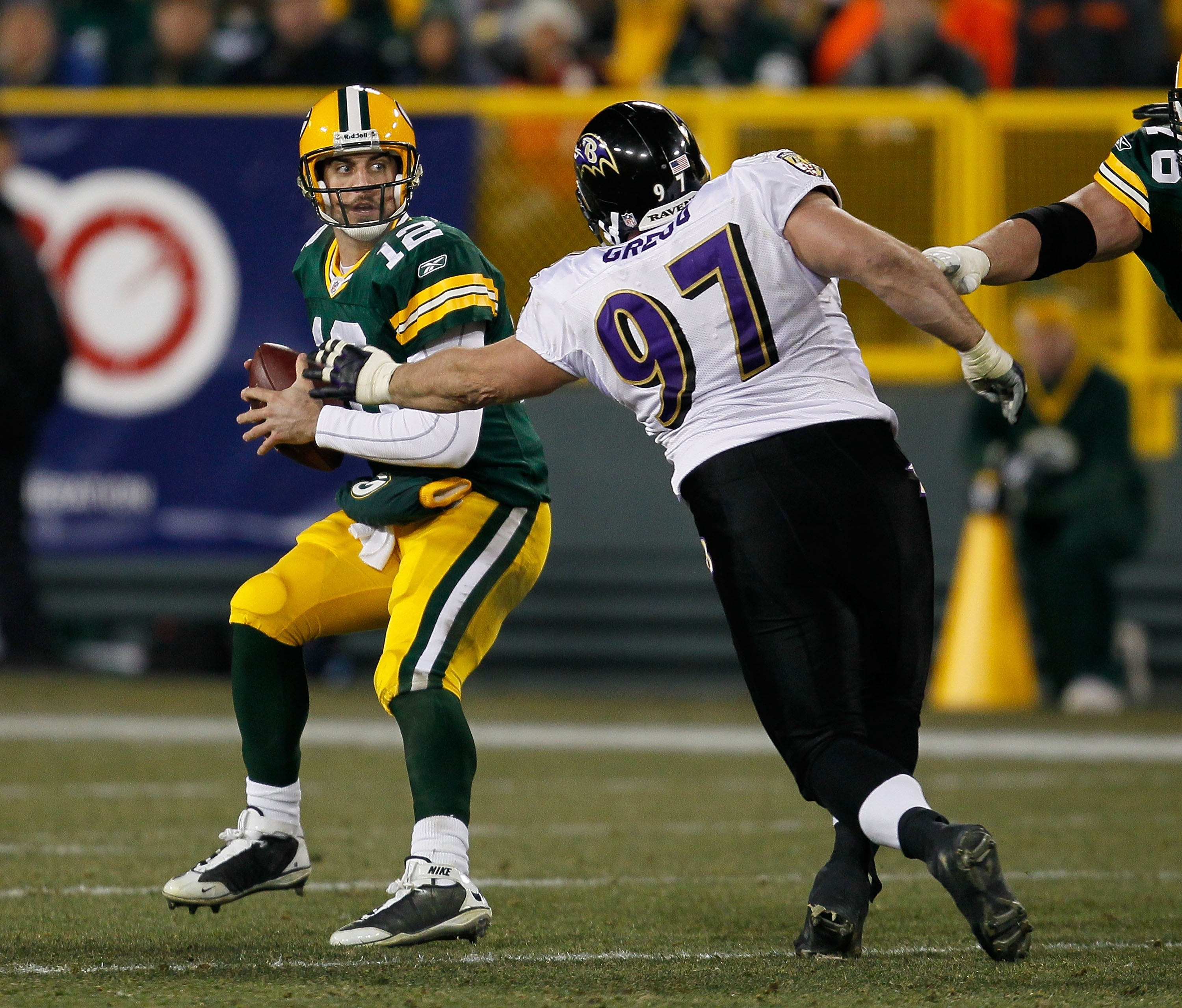 GREEN BAY, WI - DECEMBER 07: Aaron Rodgers #12 of the Green Bay Packers tries to escape from Kelly Gregg #97 of the Baltimore Ravens at Lambeau Field on December 7, 2009 in Green Bay, Wisconsin. The Packers defeated the Ravens 27-17. (Photo by Jonathan Da GREEN BAY, WI - DECEMBER 07: Aaron Rodgers #12 of the Green Bay Packers tries to escape from Kelly Gregg #97 of the Baltimore Ravens at Lambeau Field on December 7, 2009 in Green Bay, Wisconsin. The Packers defeated the Ravens 27-17. (Photo by Jonathan Da