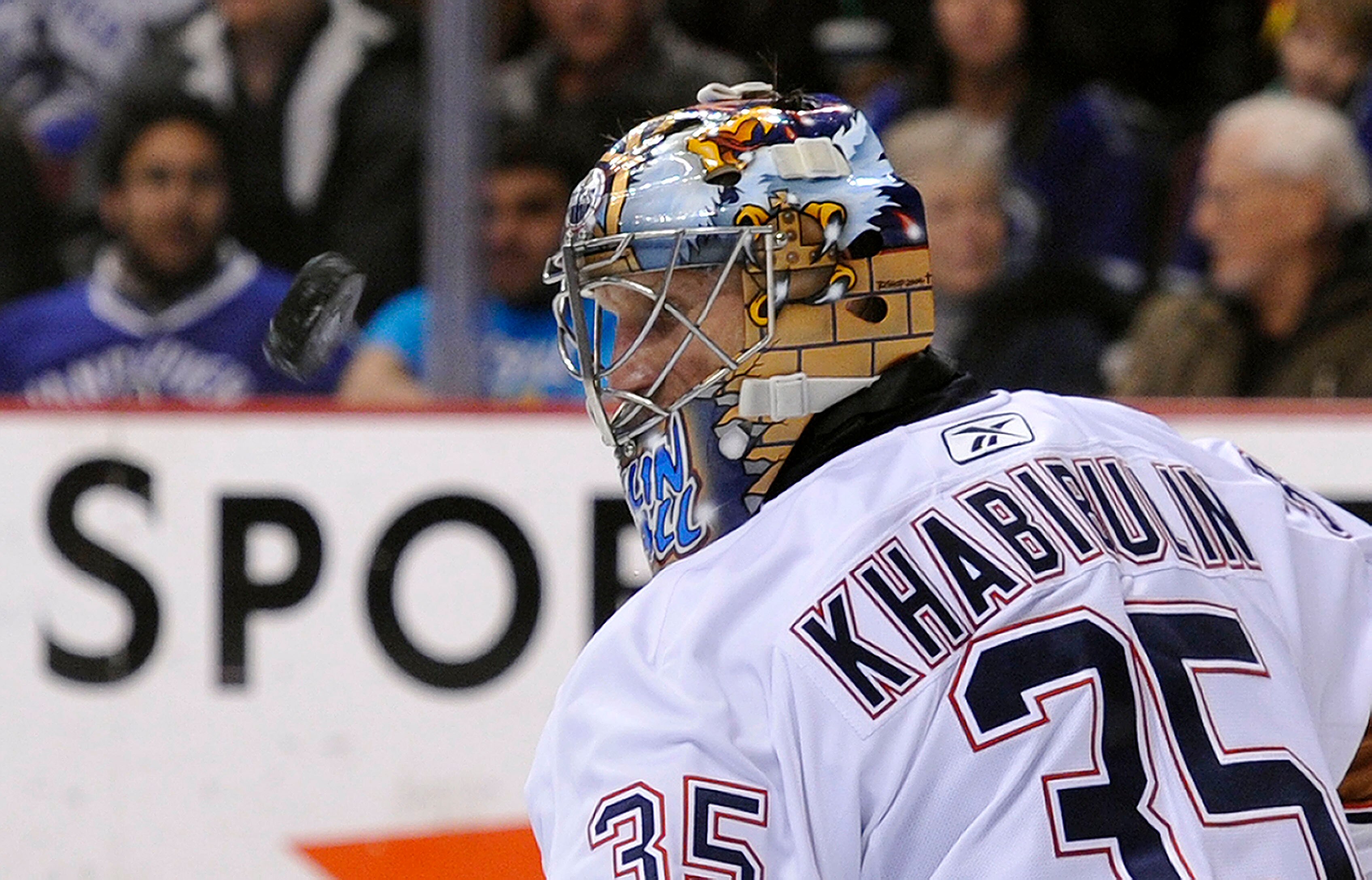 VANCOUVER, CANADA - DECEMBER 26: Goalie Nikolai Khabibulin #35 of the Edmonton Oilers keeps an eye on the airborne pauck after making a save against the Vancouver Canucks during the second period in NHL action on December 26, 2010 at Rogers Arena in Vanco
