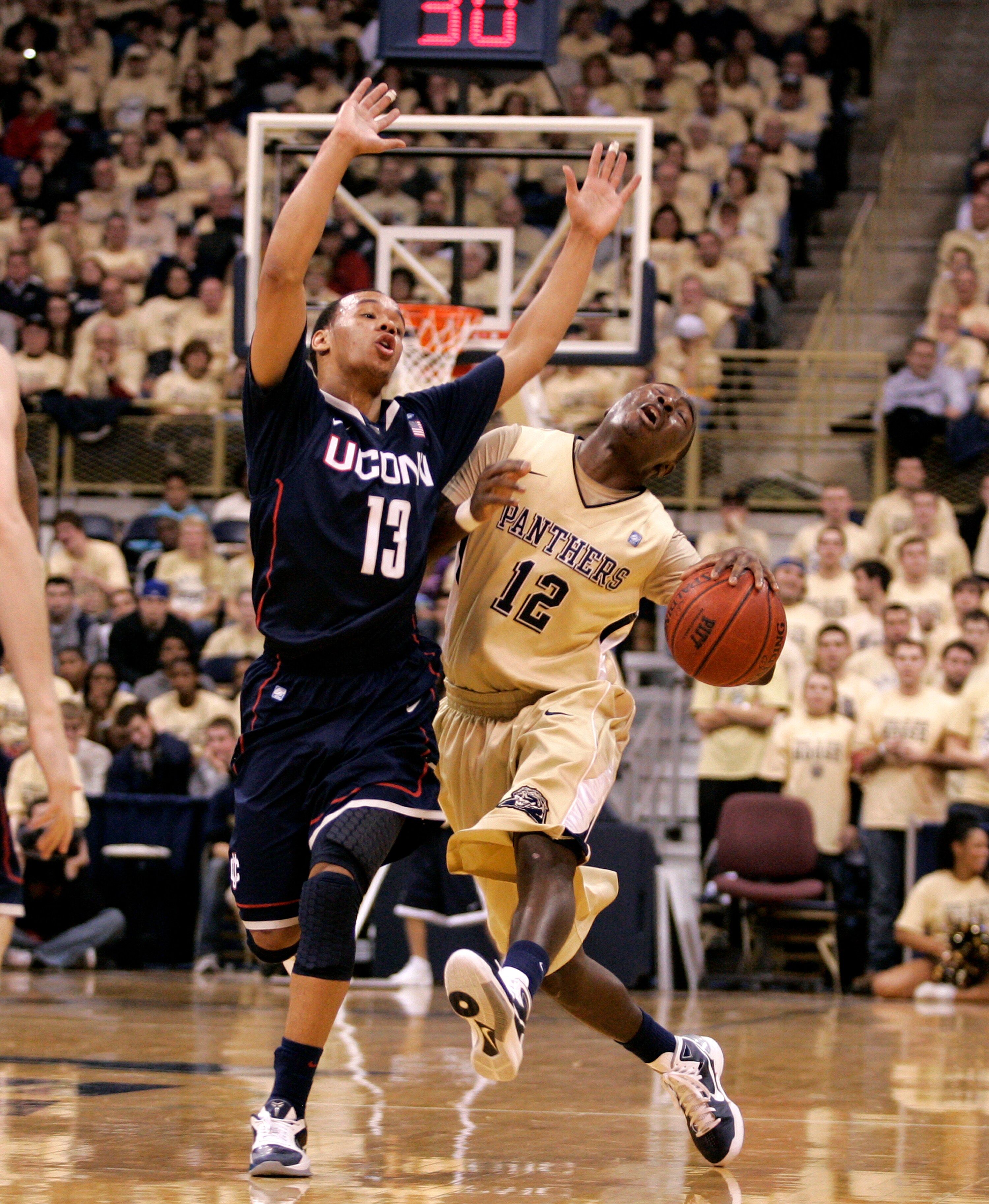 PITTSBURGH, PA - DECEMBER 27:  Ashton Gibbs #12 of the Pittsburgh Panthers reacts to being hit in the head by Shabazz Napier #13 of the Connecticut Huskies at Petersen Events Center on December 27, 2010 in Pittsburgh, Pennsylvania.  Pittsburgh defeated Co
