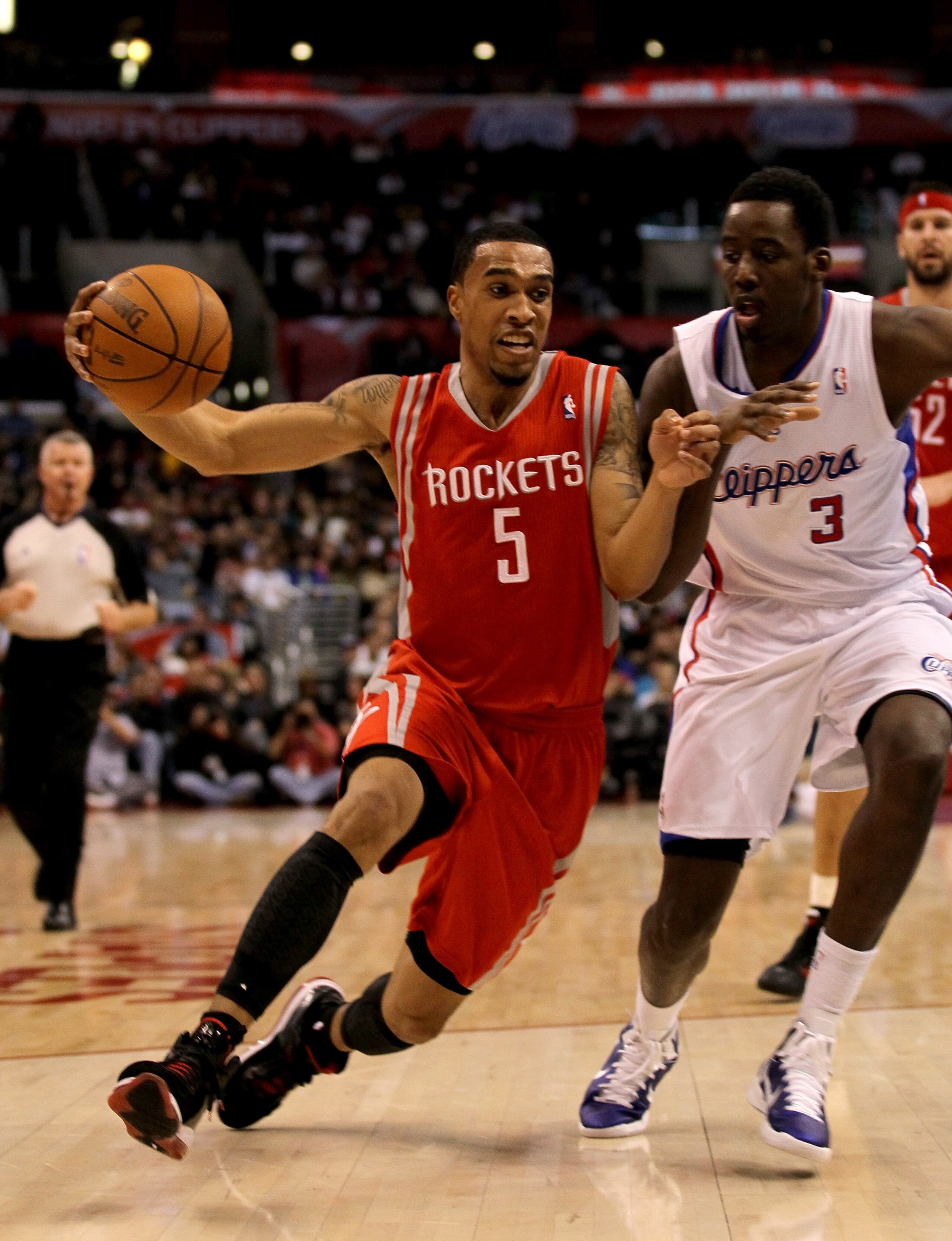 LOS ANGELES, CA - DECEMBER 22:  Courtney Lee #5 of the Houston Rockets drives around Al-Farouq Aminu #3 of the Los Angeles Clippers at Staples Center on December 22, 2010 in Los Angeles, California.  NOTE TO USER: User expressly acknowledges and agrees th