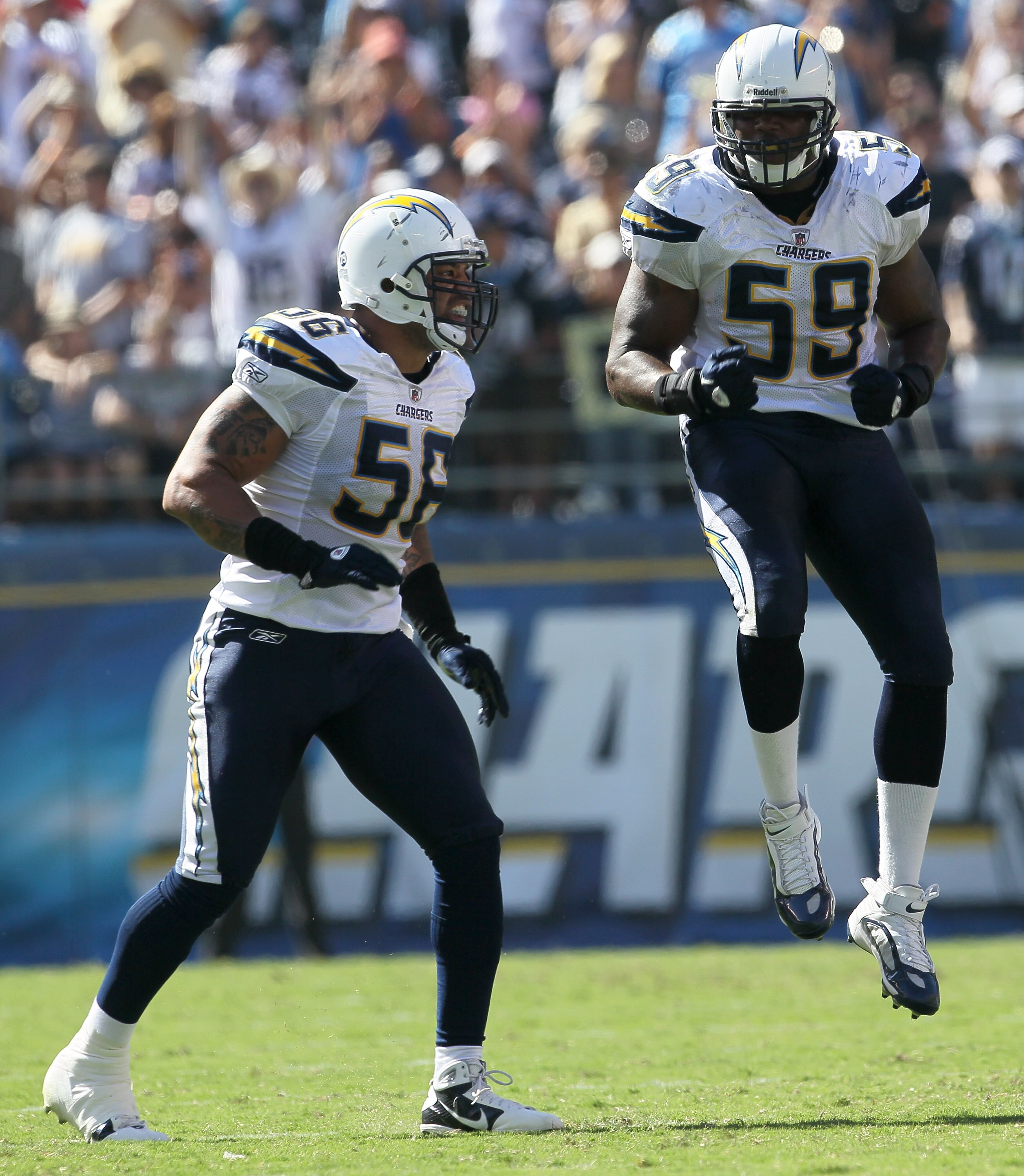 SAN DIEGO - SEPTEMBER 19:  Linebackers Shawne Merriman #56 and Larry Hart #59 of the San Diego Chargers celebrate a turnover against the Jacksonville Jaguars at Qualcomm Stadium on September 19, 2010 in San Diego, California. The Chargers won 38-13.  (Pho