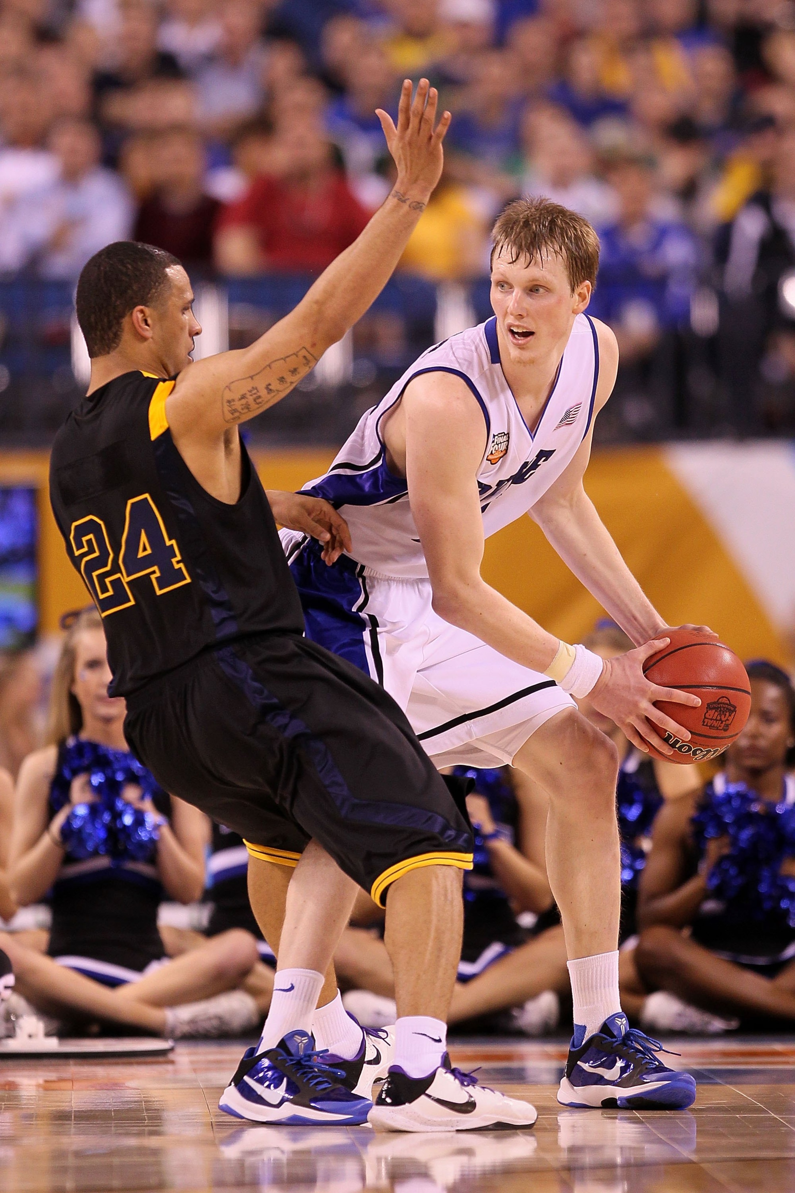INDIANAPOLIS - APRIL 03: Kyle Singler #15 of the Duke Blue Devils with the ball against Joe Mazzulla #24 of the West Virginia Mountaineers during the National Semifinal game of the 2010 NCAA Division I Men's Basketball Championship at Lucas Oil Stadium o INDIANAPOLIS - APRIL 03: Kyle Singler #15 of the Duke Blue Devils with the ball against Joe Mazzulla #24 of the West Virginia Mountaineers during the National Semifinal game of the 2010 NCAA Division I Men's Basketball Championship at Lucas Oil Stadium o