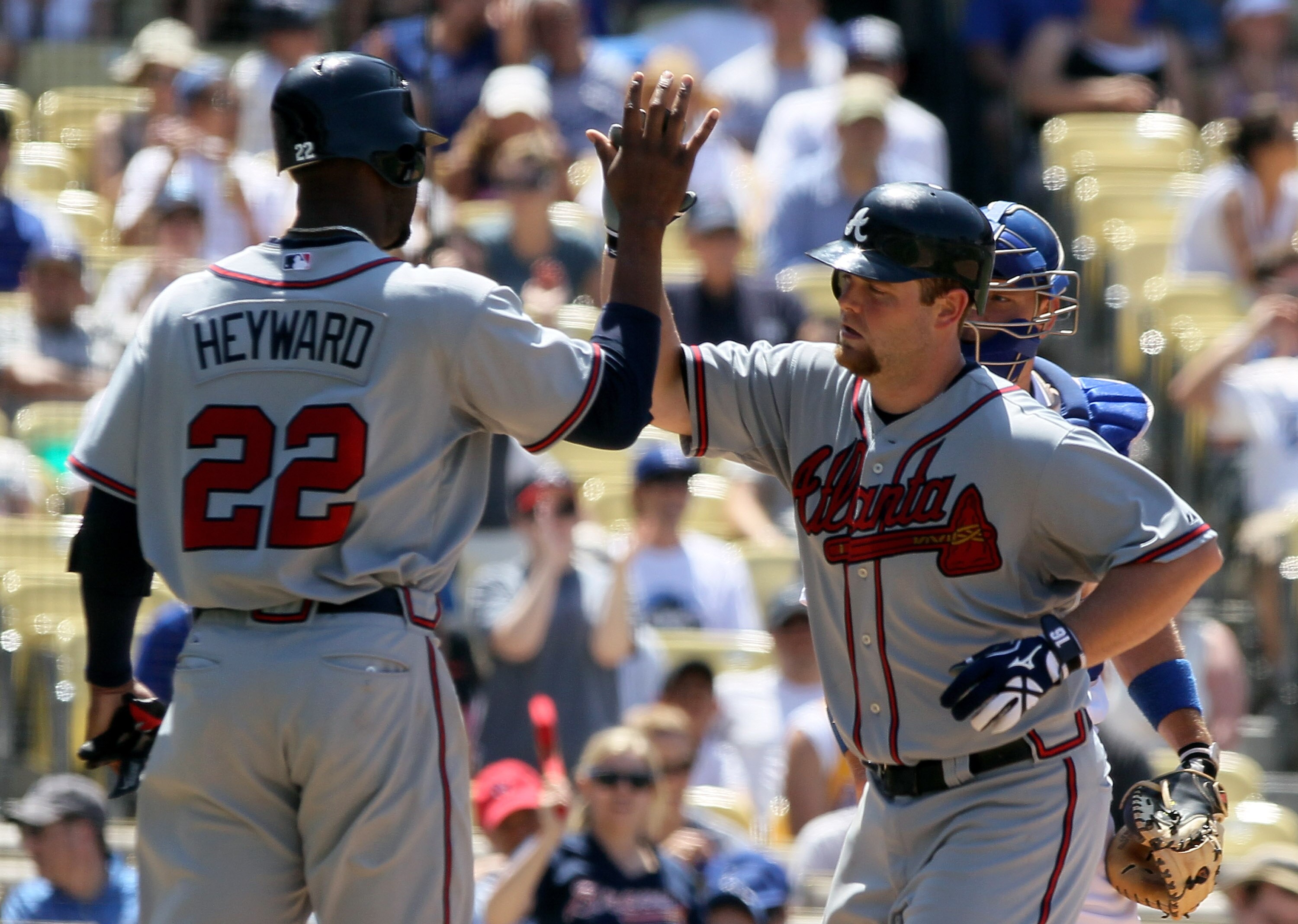 LOS ANGELES, CA - JUNE 06:  Brian McCann #16 of the Atlanta Braves receives a high five from Jason Heyward #22 after hitting a two-run homerun in the fifth inning against the Los Angeles Dodgers at Dodger Stadium on June 6, 2010 in Los Angeles, California