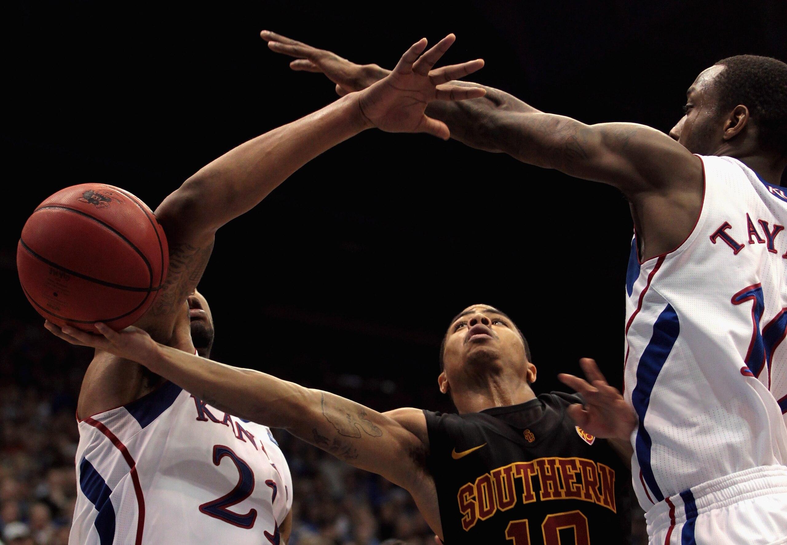 LAWRENCE, KS - DECEMBER 18: Maurice Jones #10 of the USC Trojans shoots as Markieff Morris #21 and Tyshawn Taylor #10 of the Kansas Jayhawks defend during the game on December 18, 2010 at Allen Fieldhouse in Lawrence, Kansas. (Photo by Jamie Squire/Gett LAWRENCE, KS - DECEMBER 18: Maurice Jones #10 of the USC Trojans shoots as Markieff Morris #21 and Tyshawn Taylor #10 of the Kansas Jayhawks defend during the game on December 18, 2010 at Allen Fieldhouse in Lawrence, Kansas. (Photo by Jamie Squire/Gett